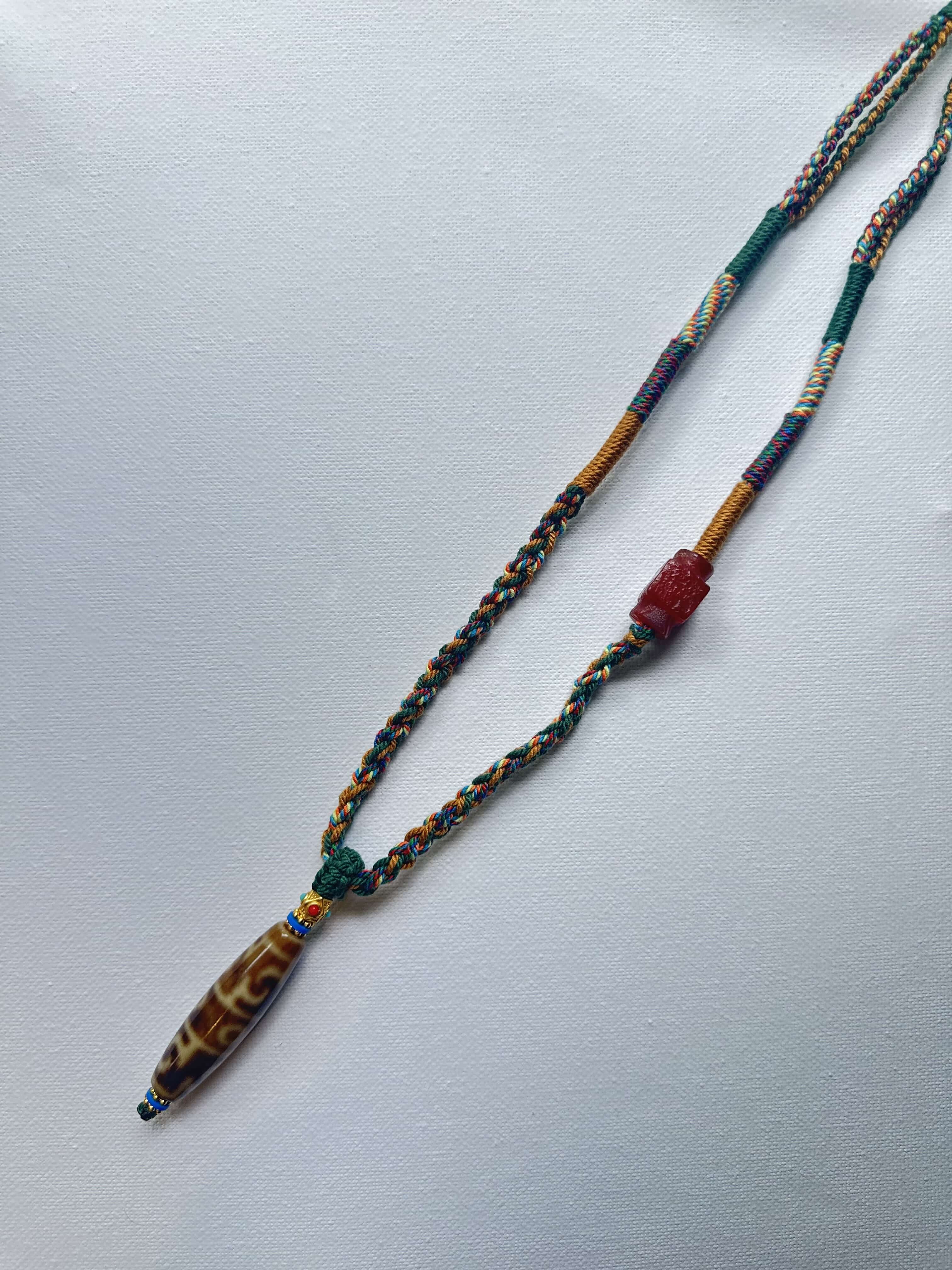 Heavily Handwoven Necklace with handmade carnelian bead and vintage Three-Eyed Dzi of Guru Rinpoche pendant.