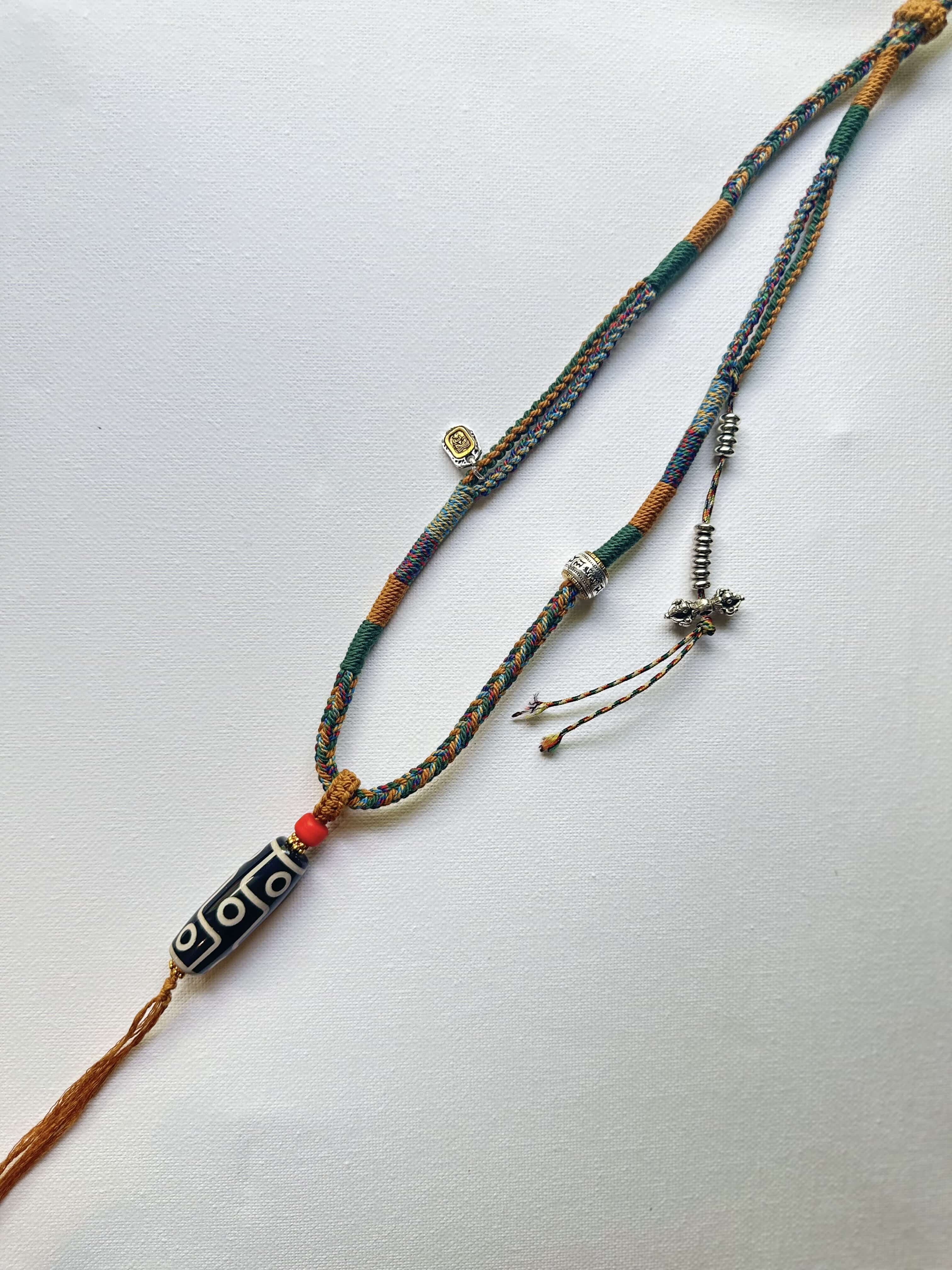 Heavily Handwoven necklace with vintage metal Himalayan accessories and nine-eyed DZI bead