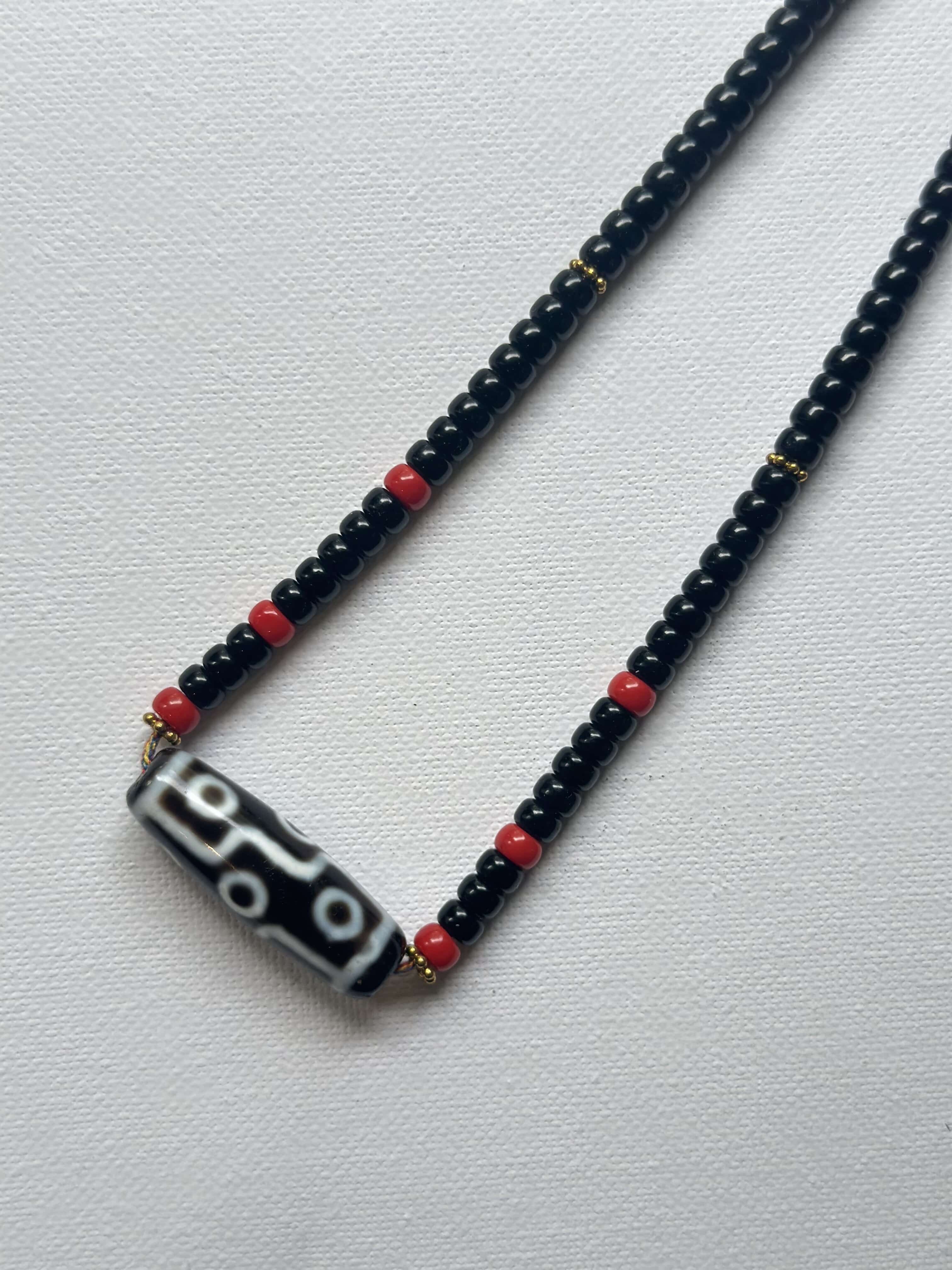 Vintage DZI necklace decorated with black and red glass beads