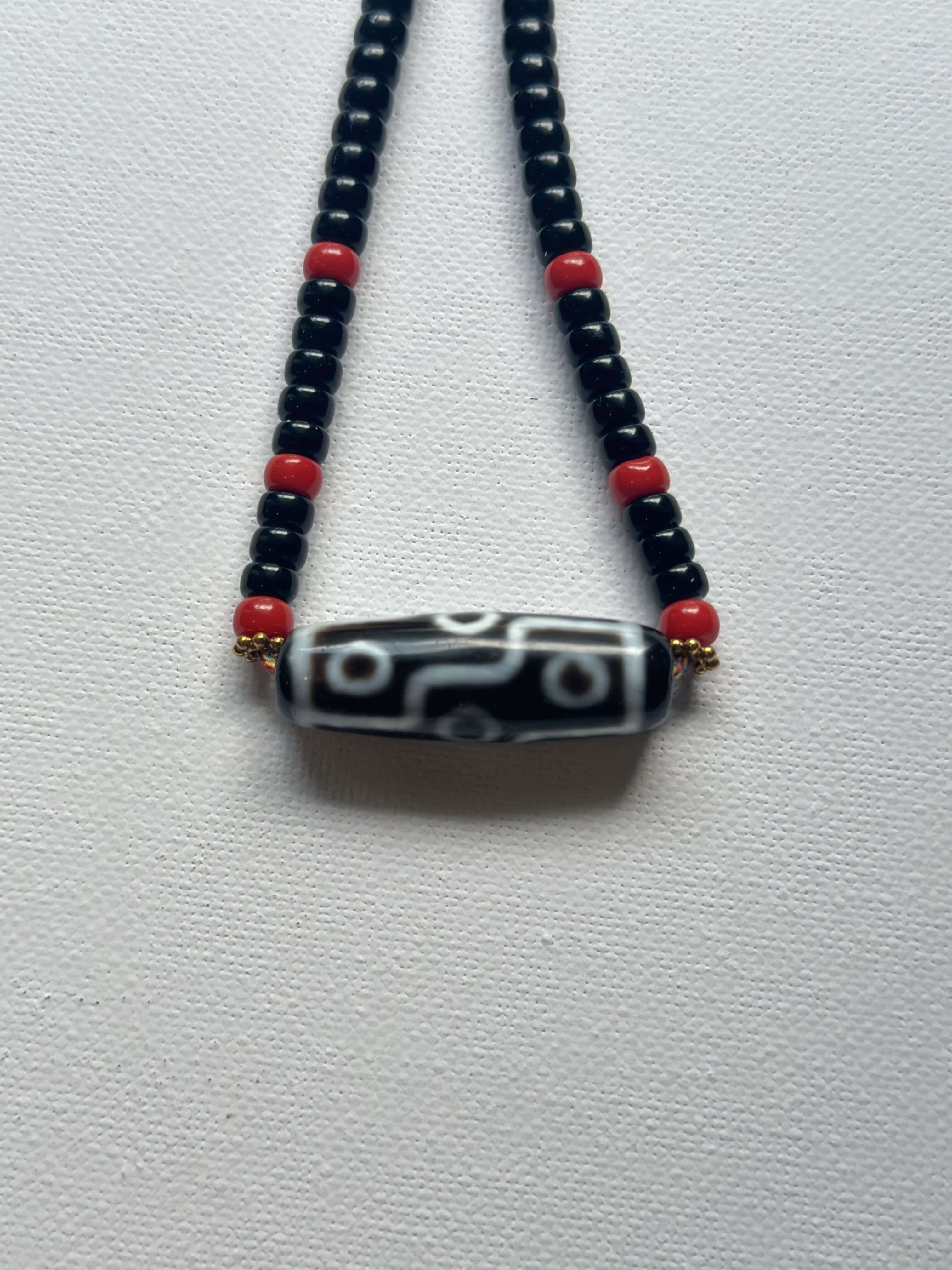Vintage DZI necklace decorated with black and red glass beads