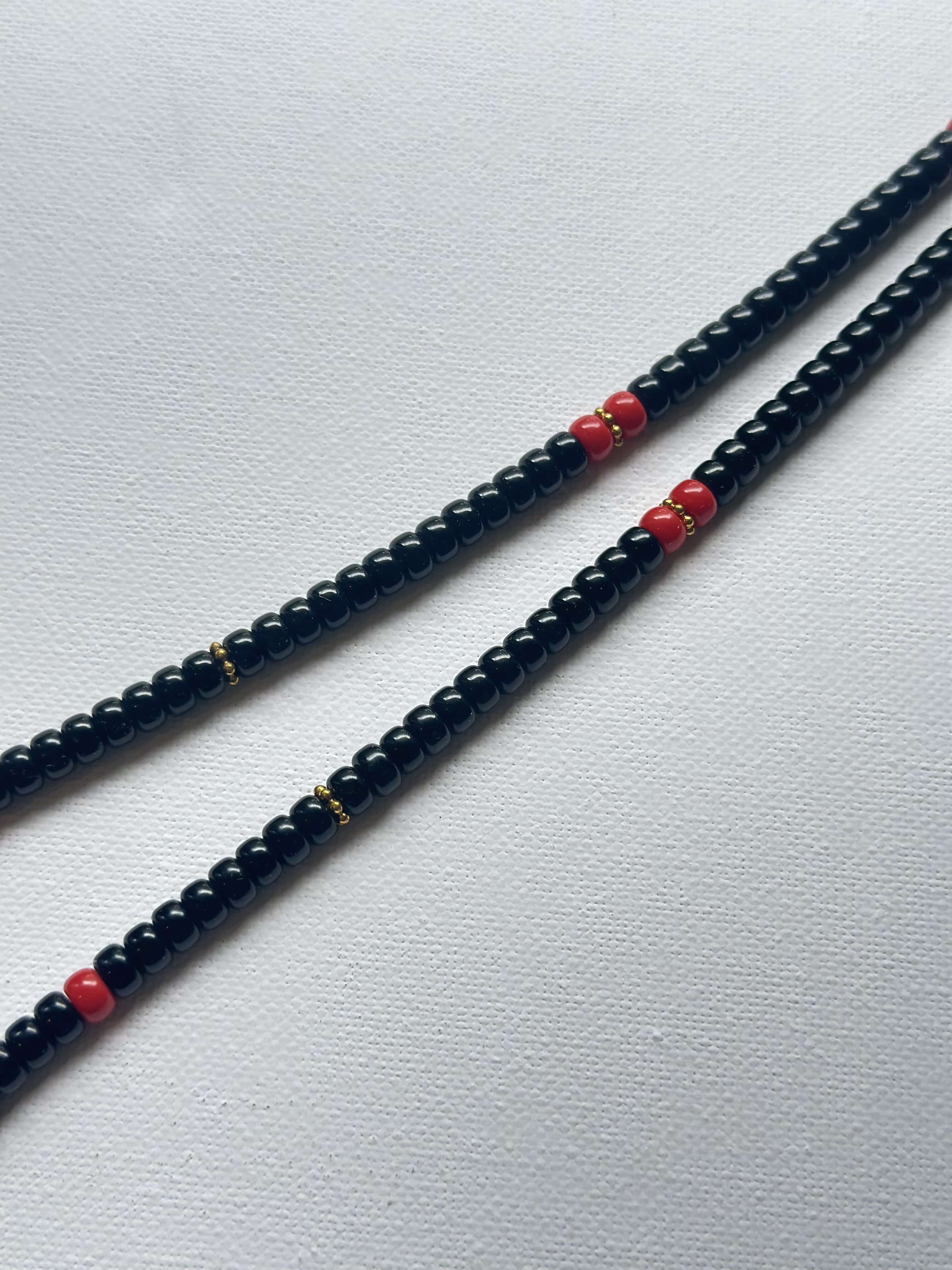 Vintage DZI necklace decorated with black and red glass beads