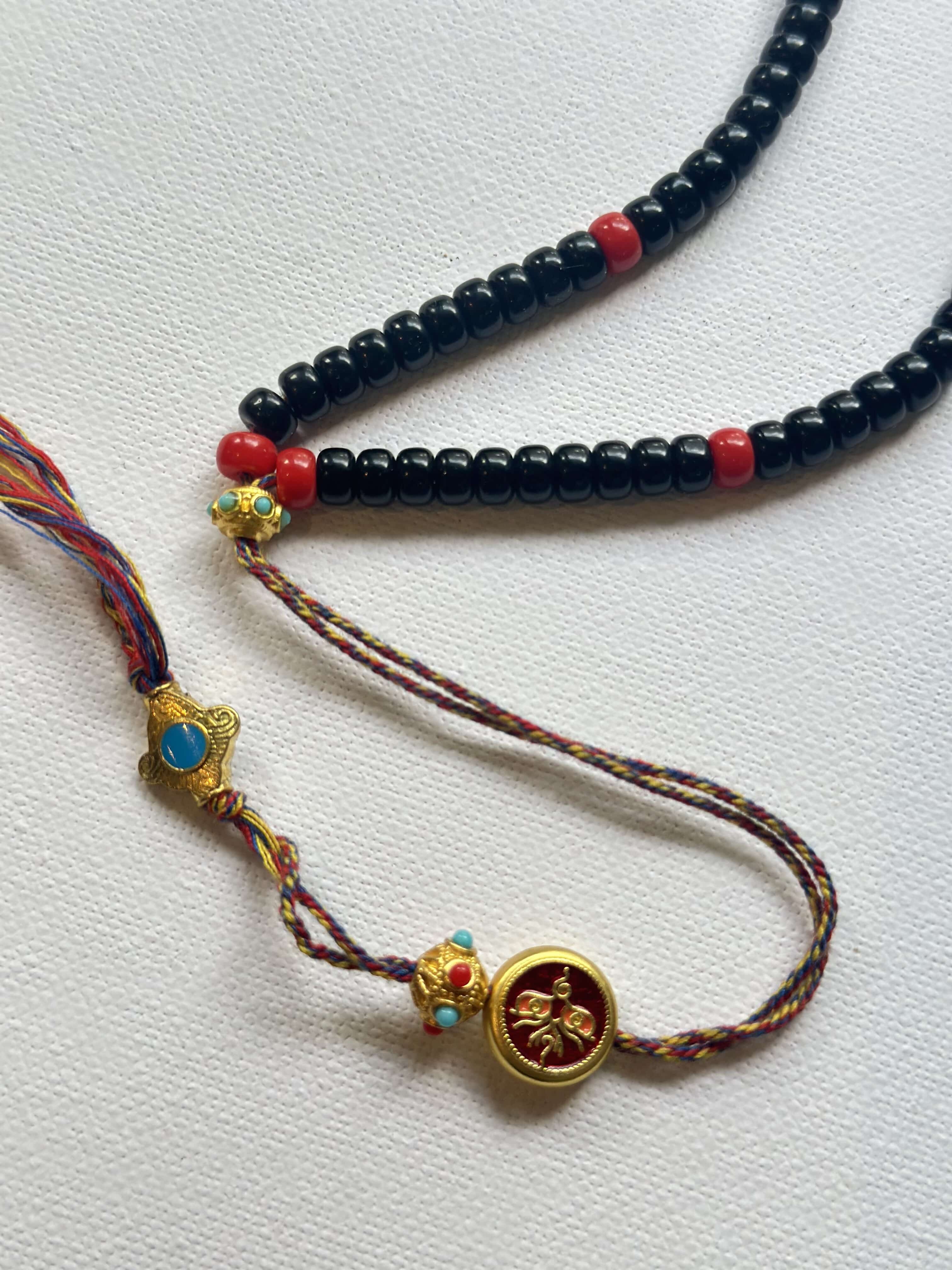 Vintage DZI necklace decorated with black and red glass beads