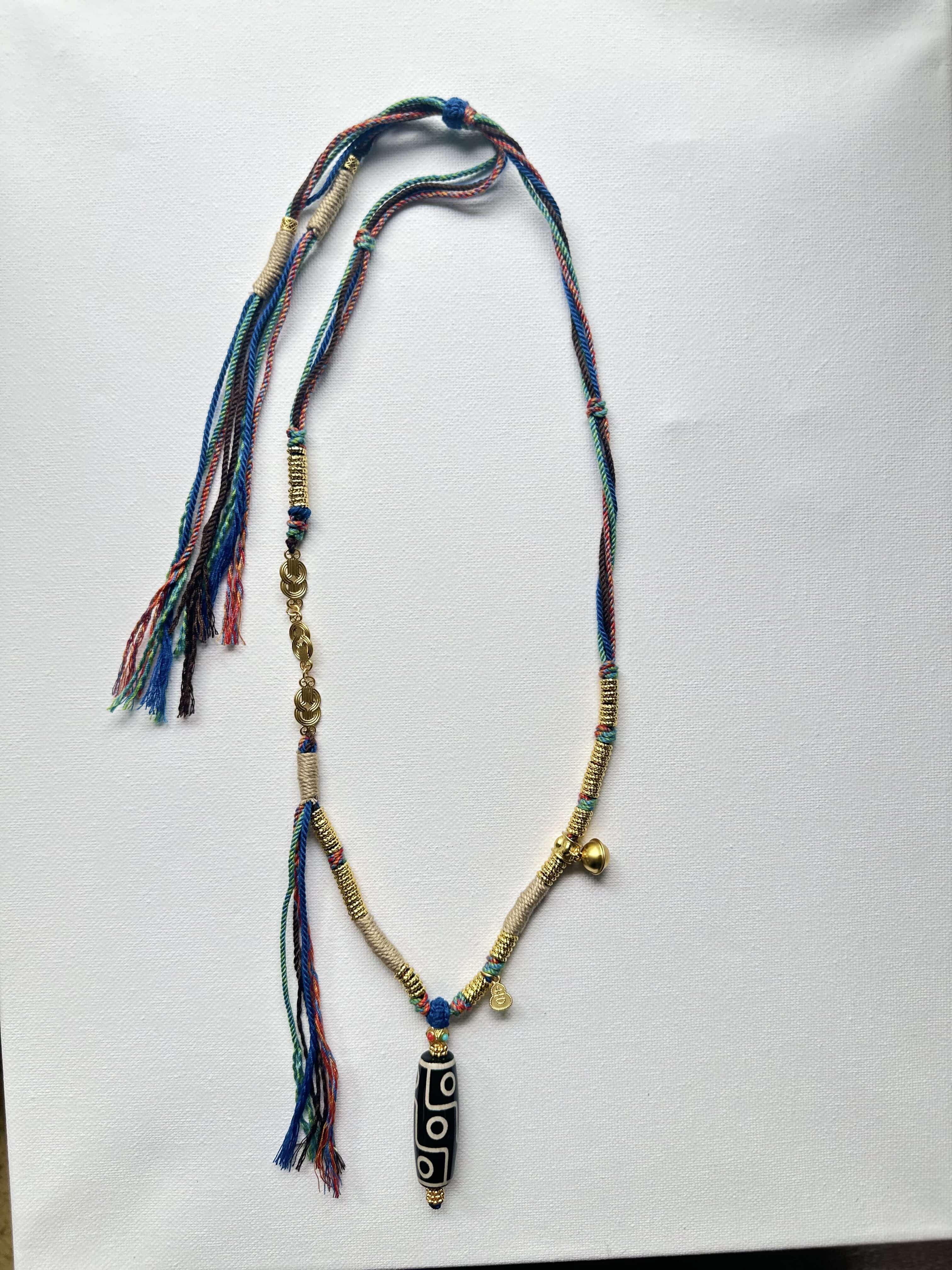 Heavily handwoven necklace with Gold plated metal lucky accessories and Vintage Nine-Eyed DZI bead pendant.