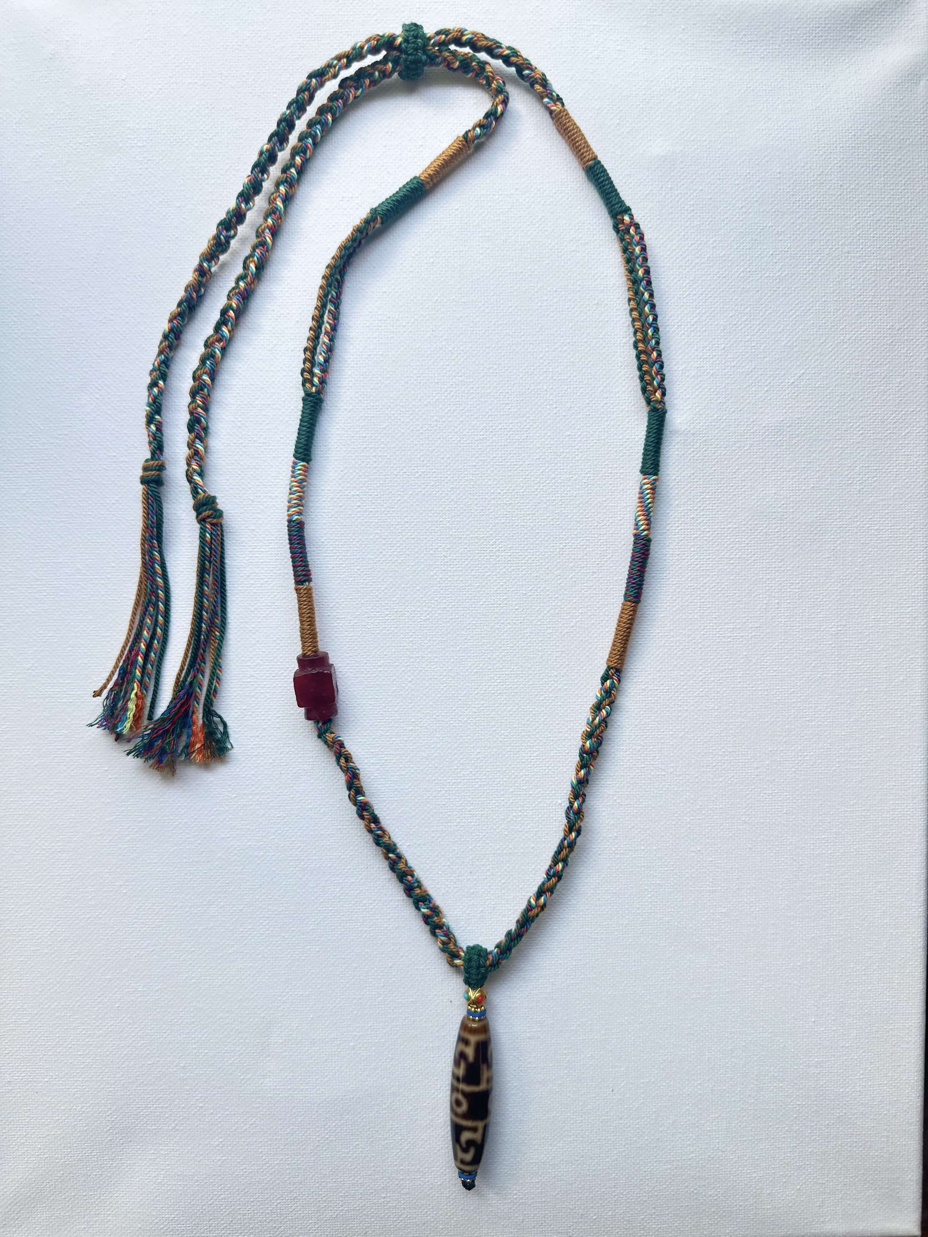 Heavily Handwoven Necklace with handmade carnelian bead and vintage Three-Eyed Dzi of Guru Rinpoche pendant.
