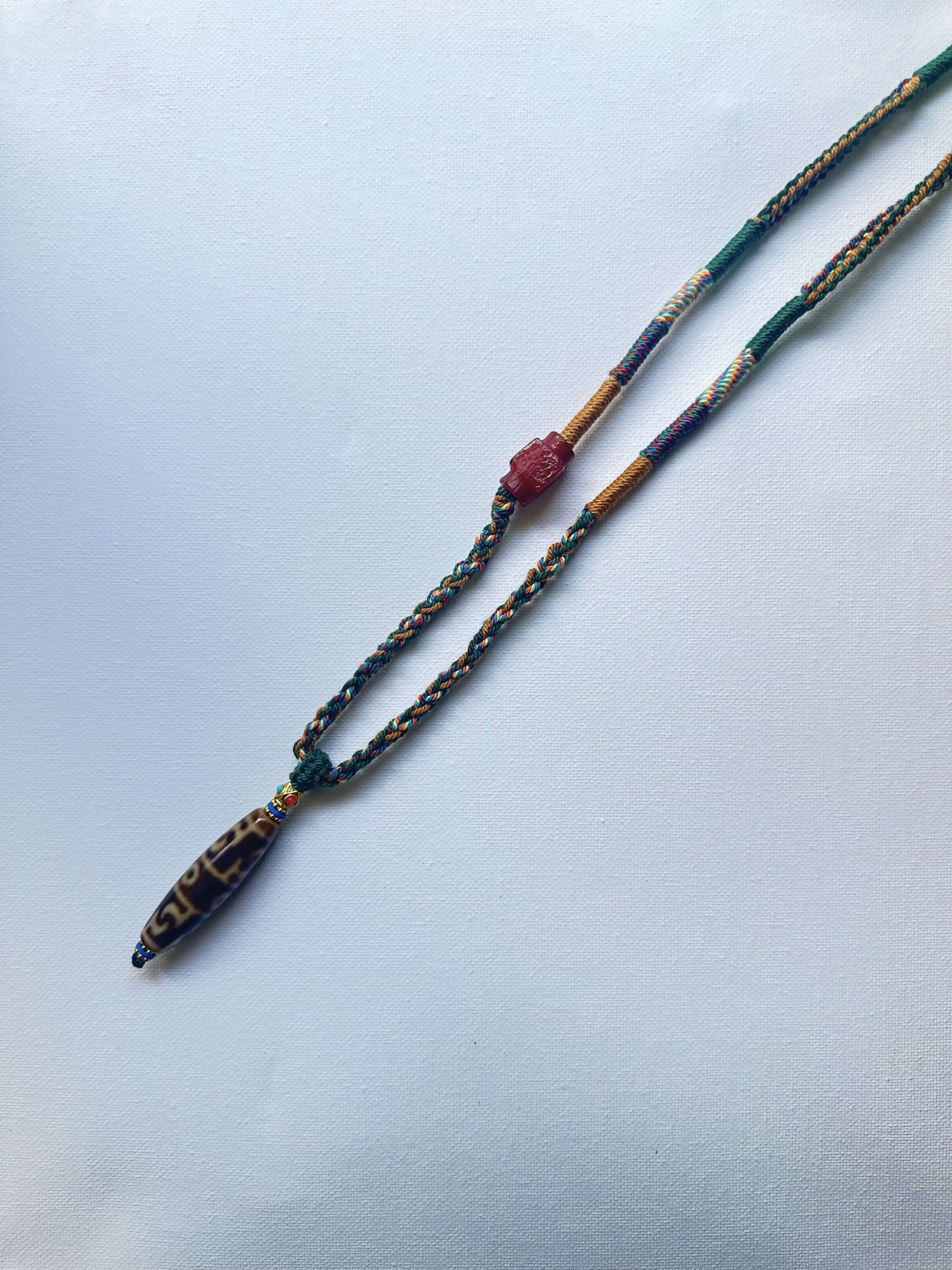 Heavily Handwoven Necklace with handmade carnelian bead and vintage Three-Eyed Dzi of Guru Rinpoche pendant.