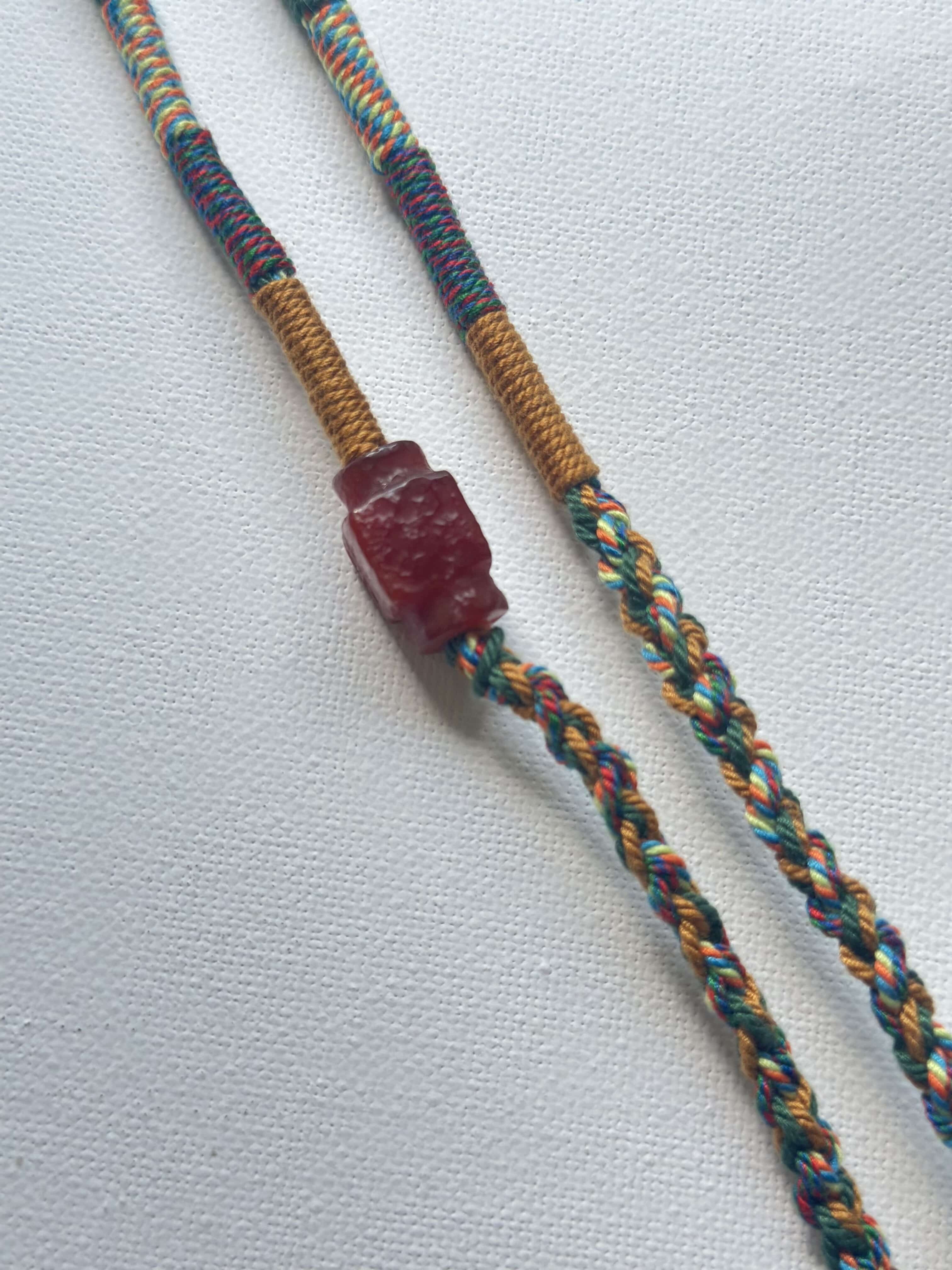 Heavily Handwoven Necklace with handmade carnelian bead and vintage Three-Eyed Dzi of Guru Rinpoche pendant.