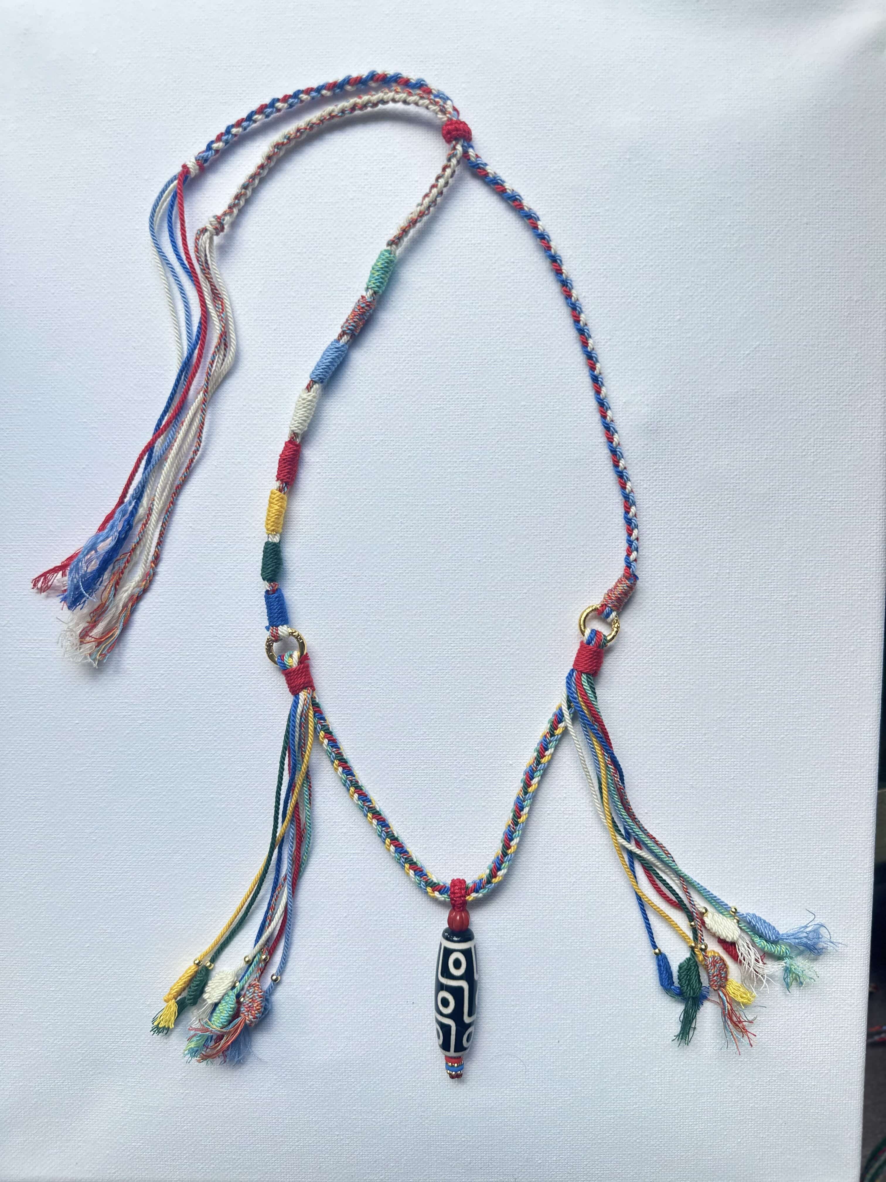 Heavily Handwoven necklace with nine-eyed DZI pendant