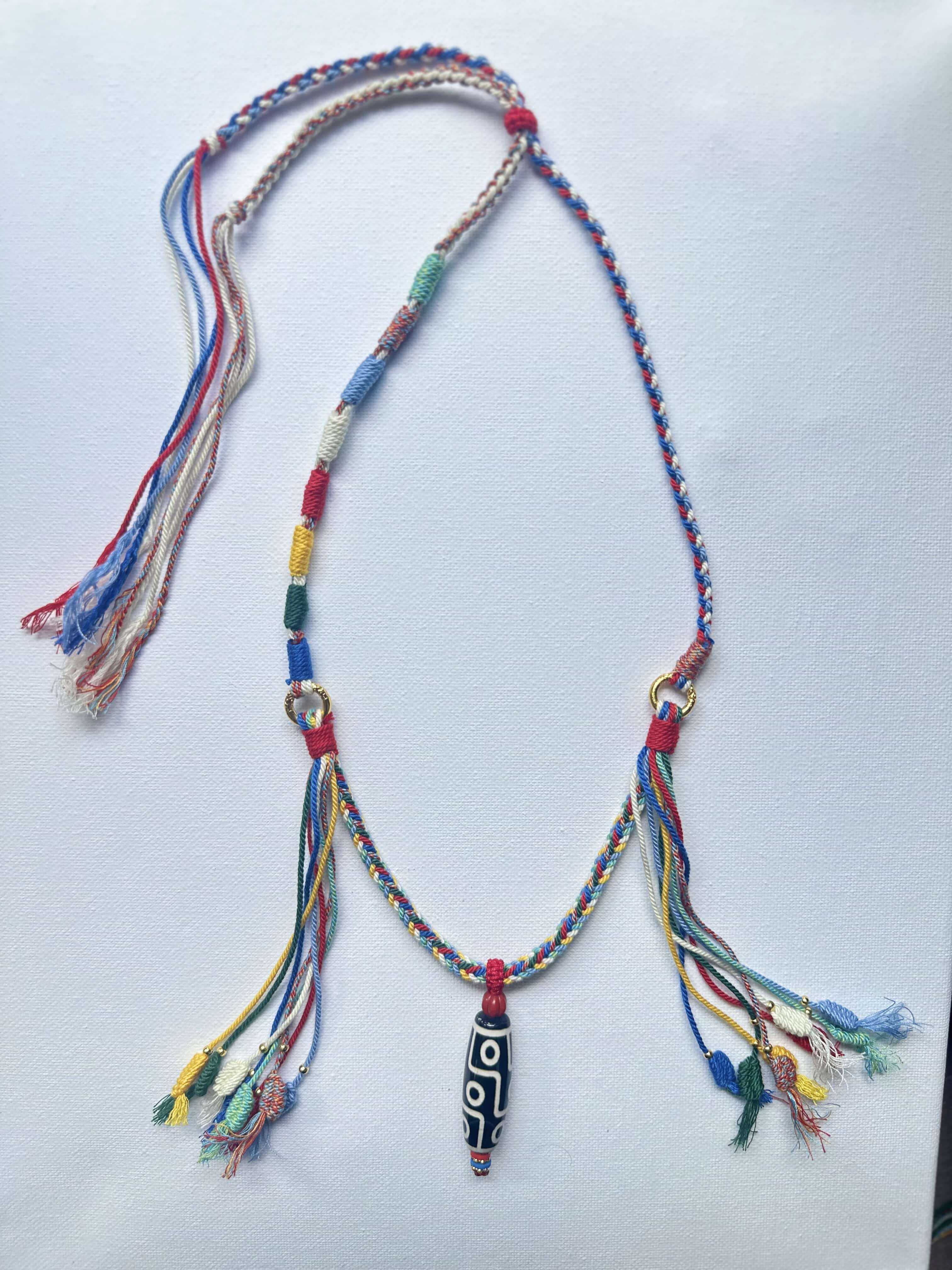 Heavily Handwoven necklace with nine-eyed DZI pendant