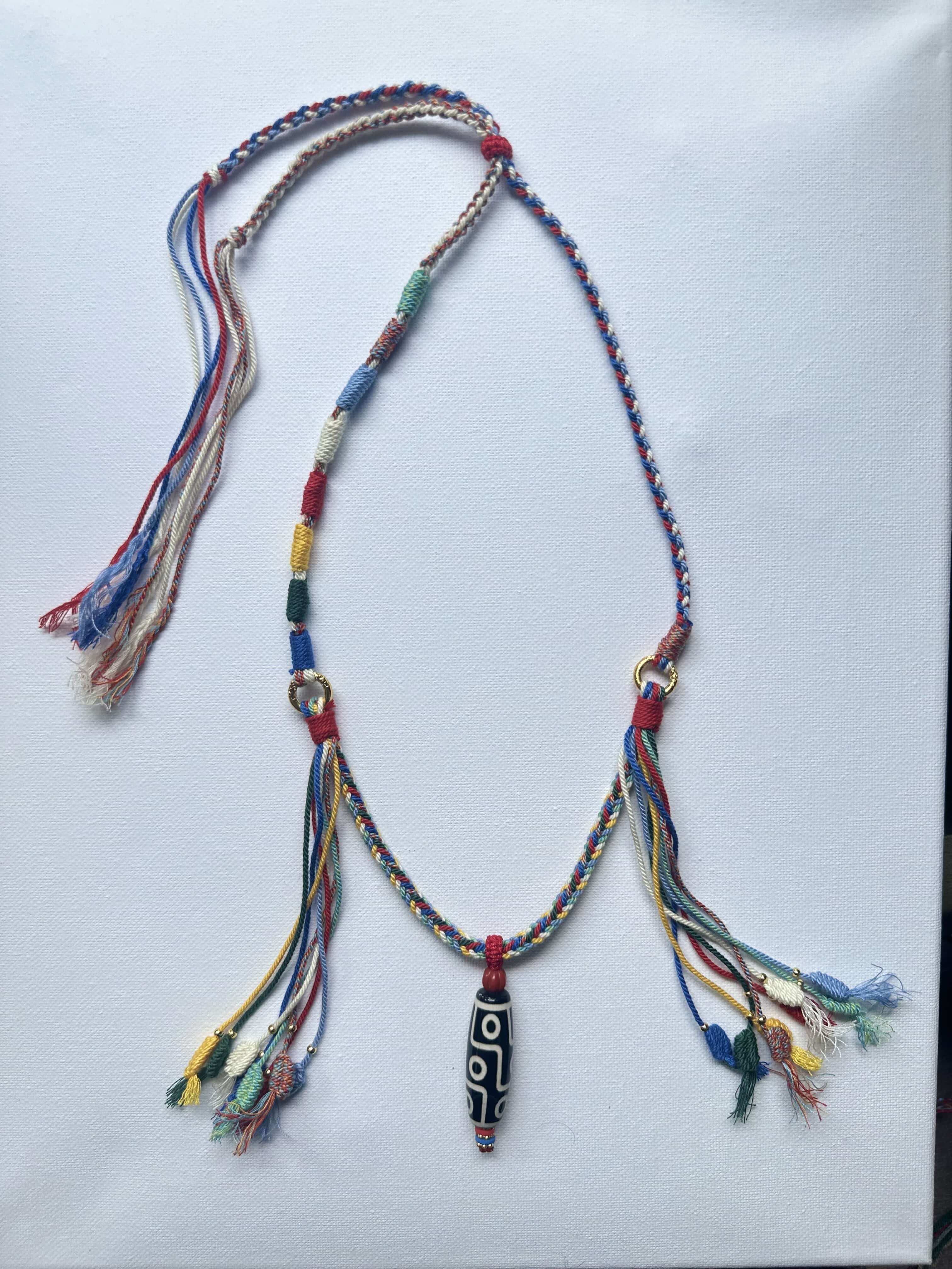 Heavily Handwoven necklace with nine-eyed DZI pendant
