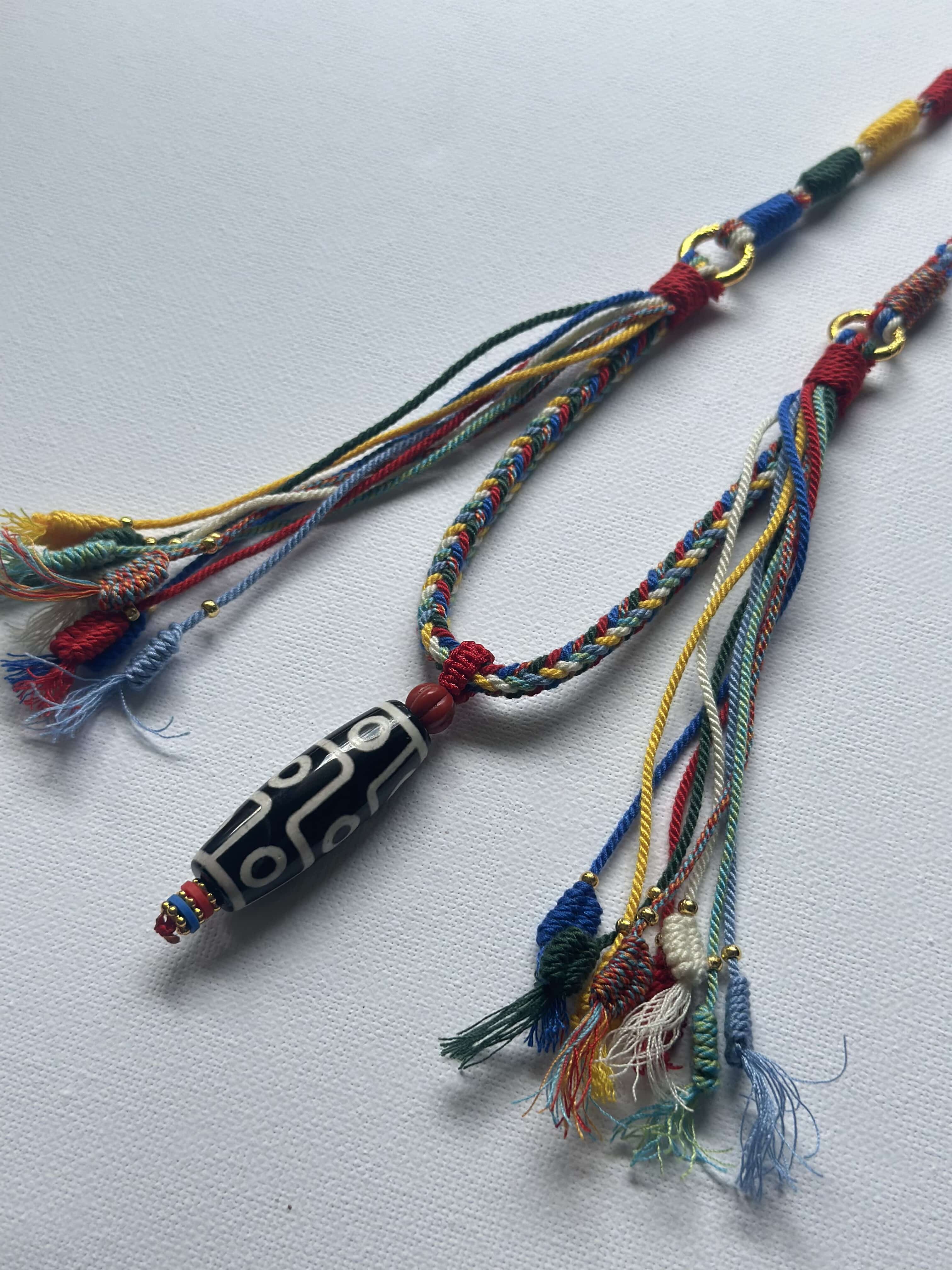 Heavily Handwoven necklace with nine-eyed DZI pendant