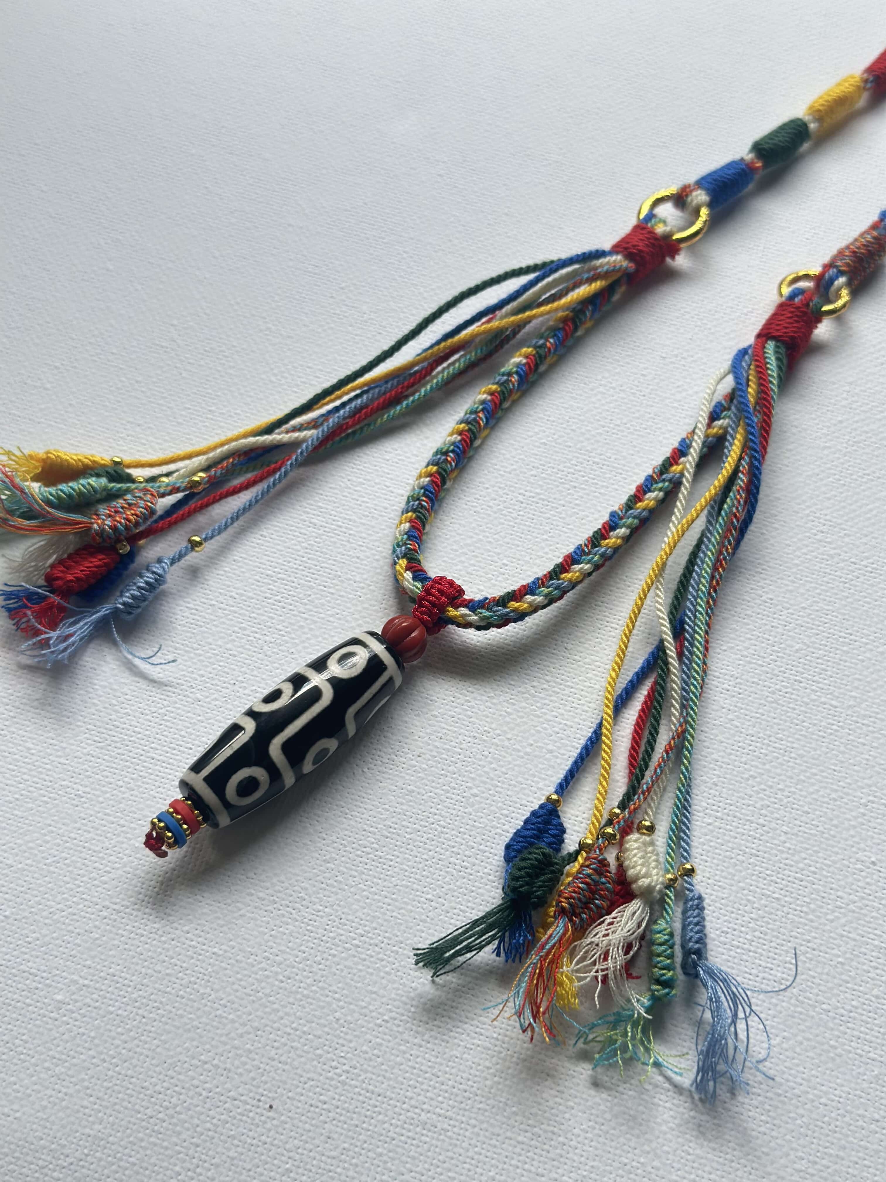Heavily Handwoven necklace with nine-eyed DZI pendant