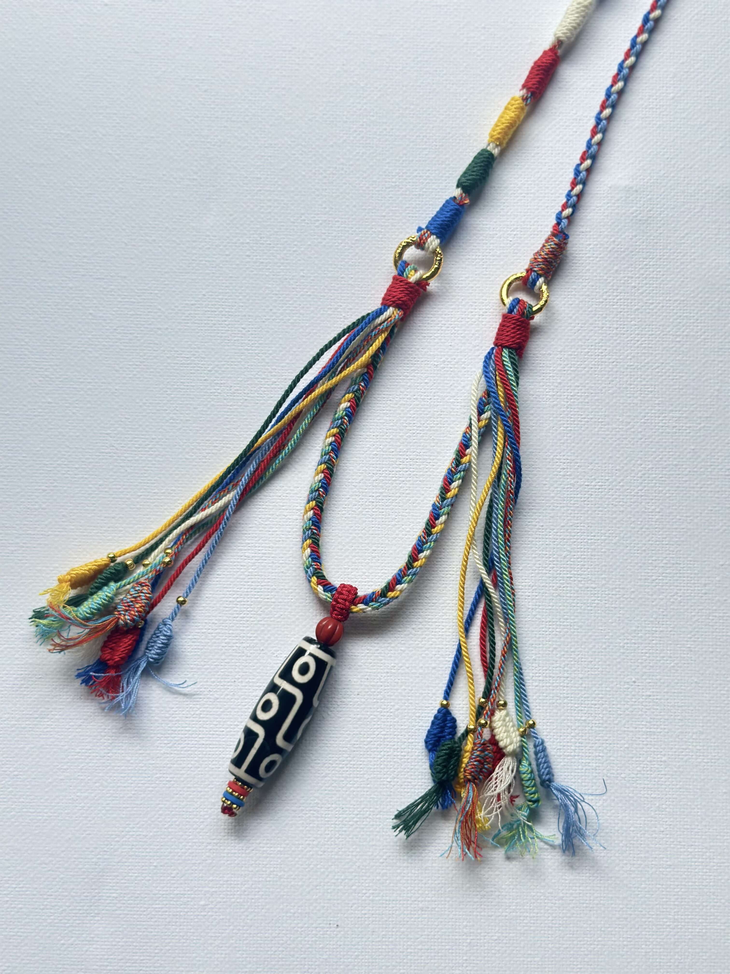 Heavily Handwoven necklace with nine-eyed DZI pendant