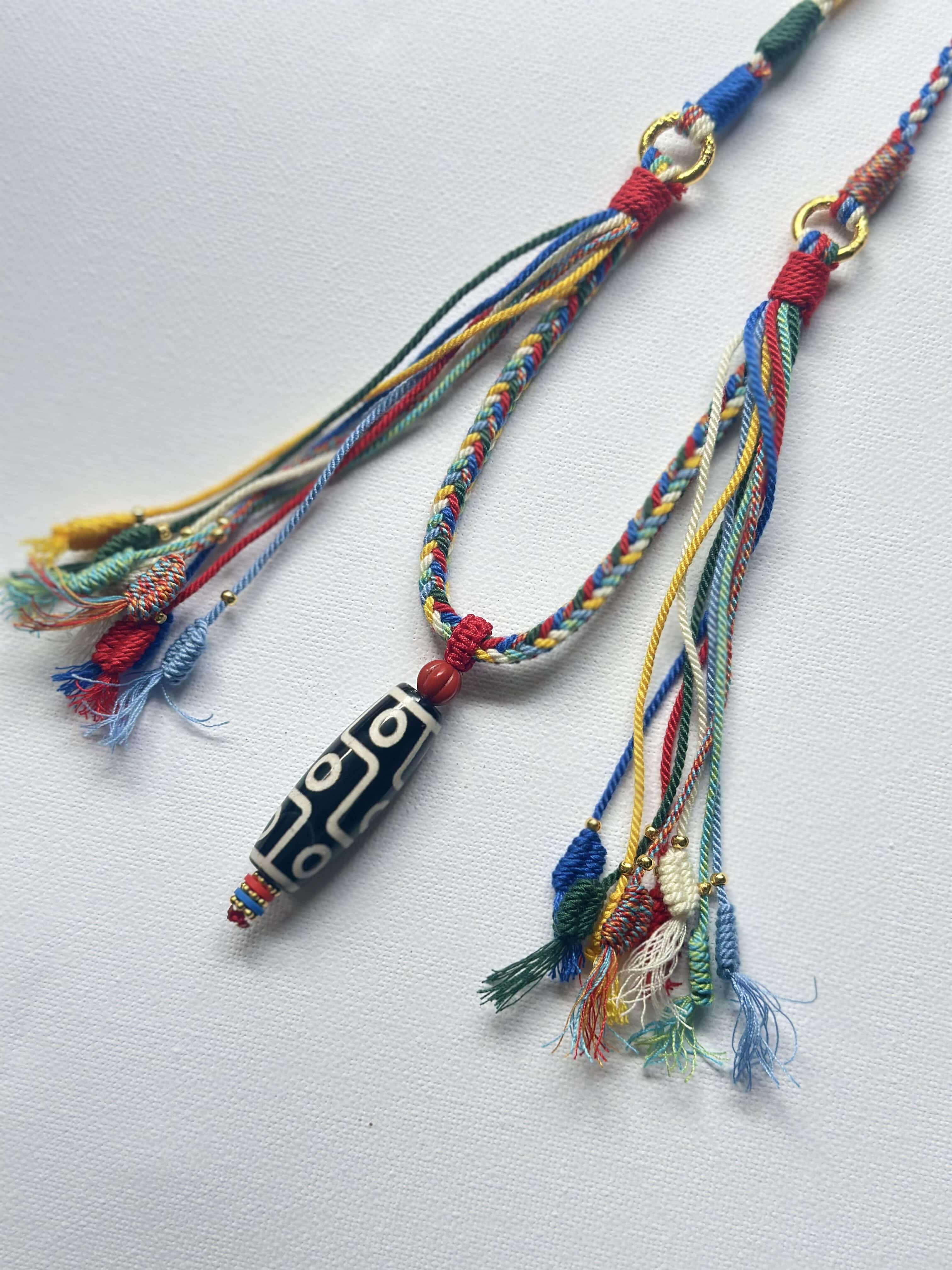 Heavily Handwoven necklace with nine-eyed DZI pendant