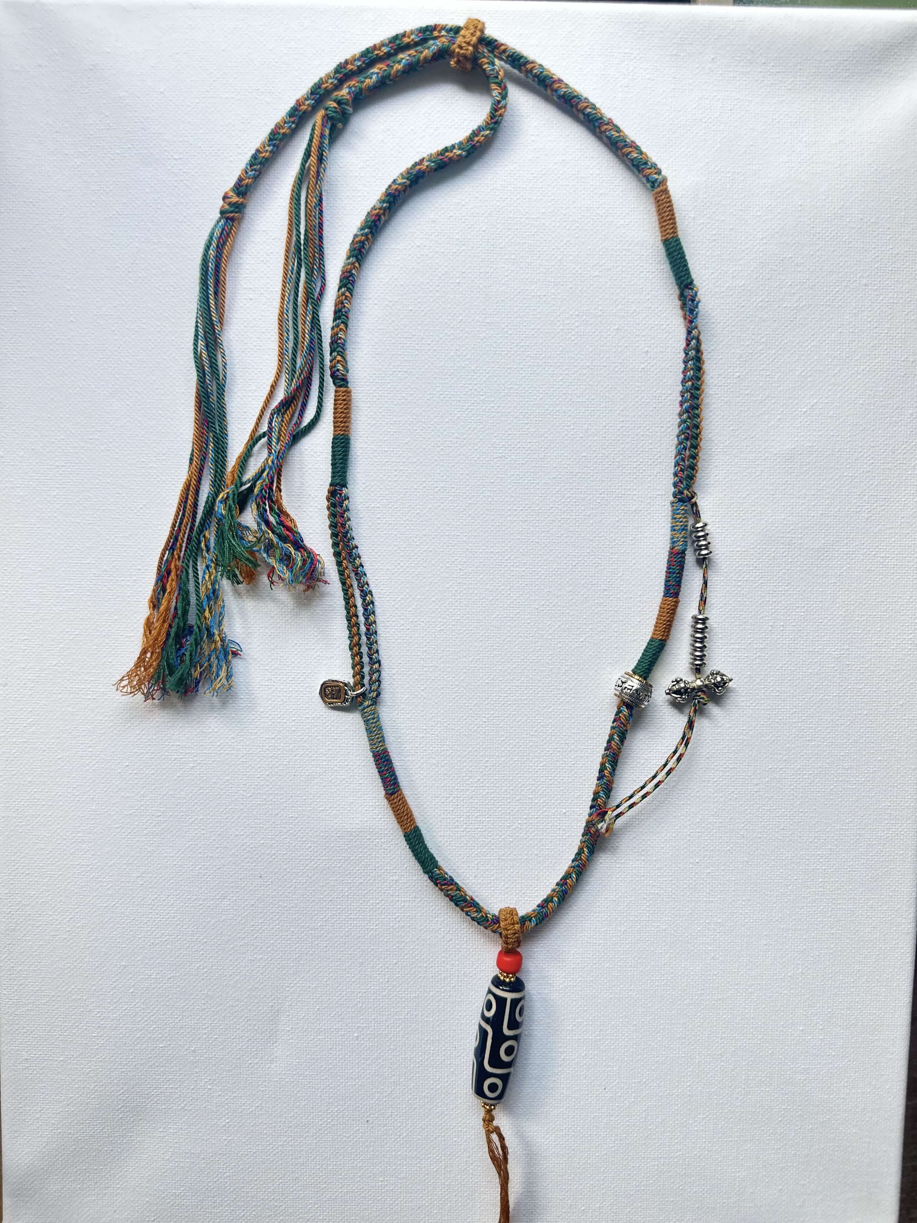Heavily Handwoven necklace with vintage metal Himalayan accessories and nine-eyed DZI bead