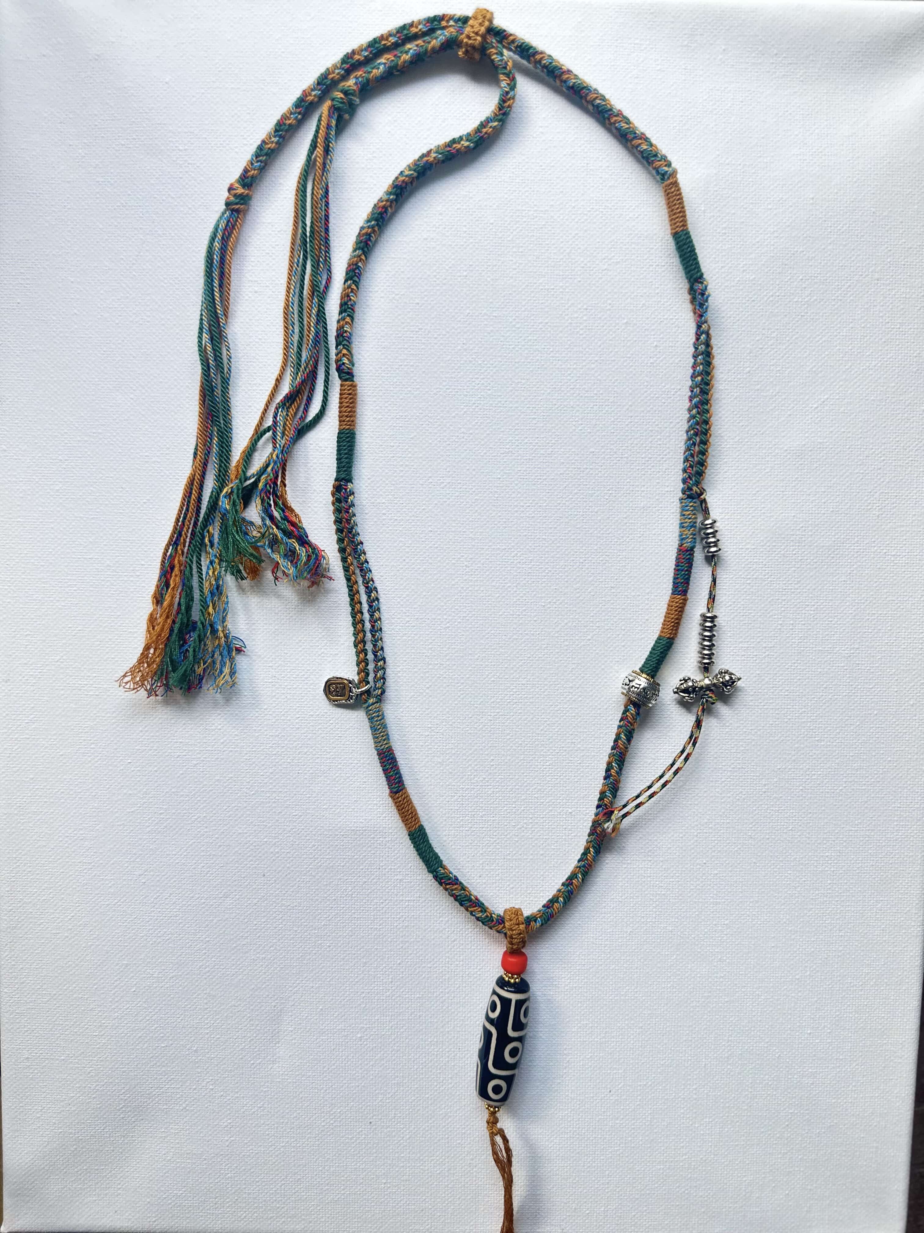 Heavily Handwoven necklace with vintage metal Himalayan accessories and nine-eyed DZI bead