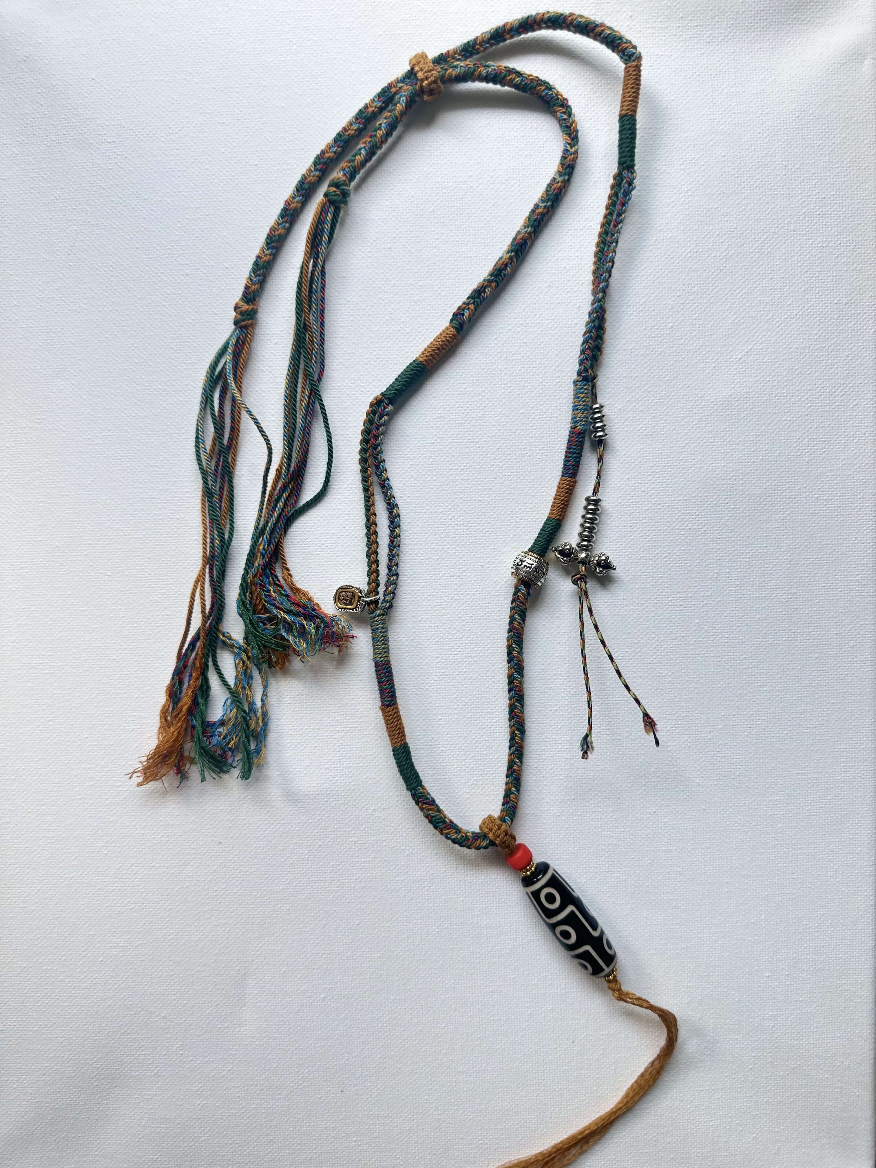 Heavily Handwoven necklace with vintage metal Himalayan accessories and nine-eyed DZI bead