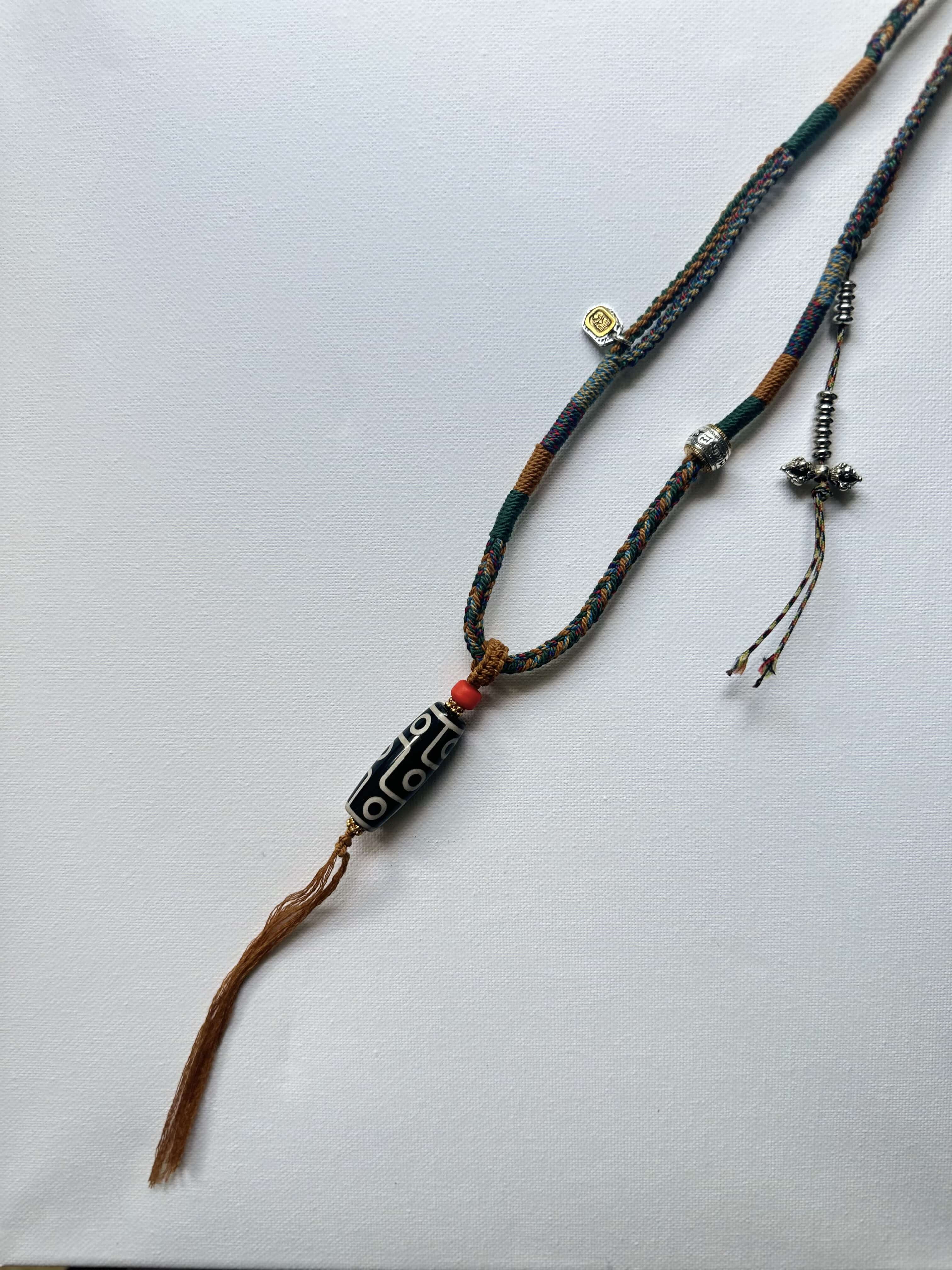 Heavily Handwoven necklace with vintage metal Himalayan accessories and nine-eyed DZI bead