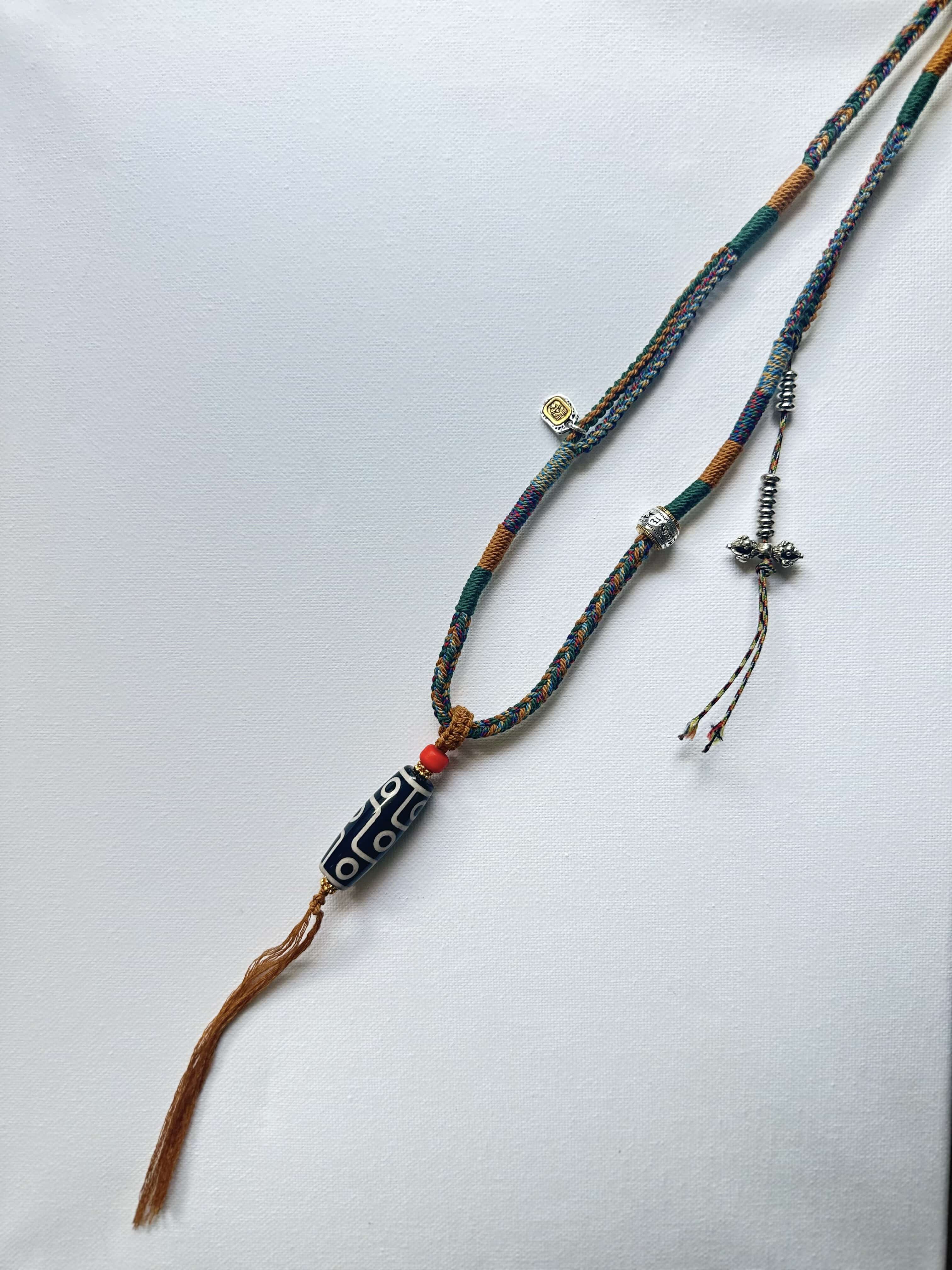 Heavily Handwoven necklace with vintage metal Himalayan accessories and nine-eyed DZI bead