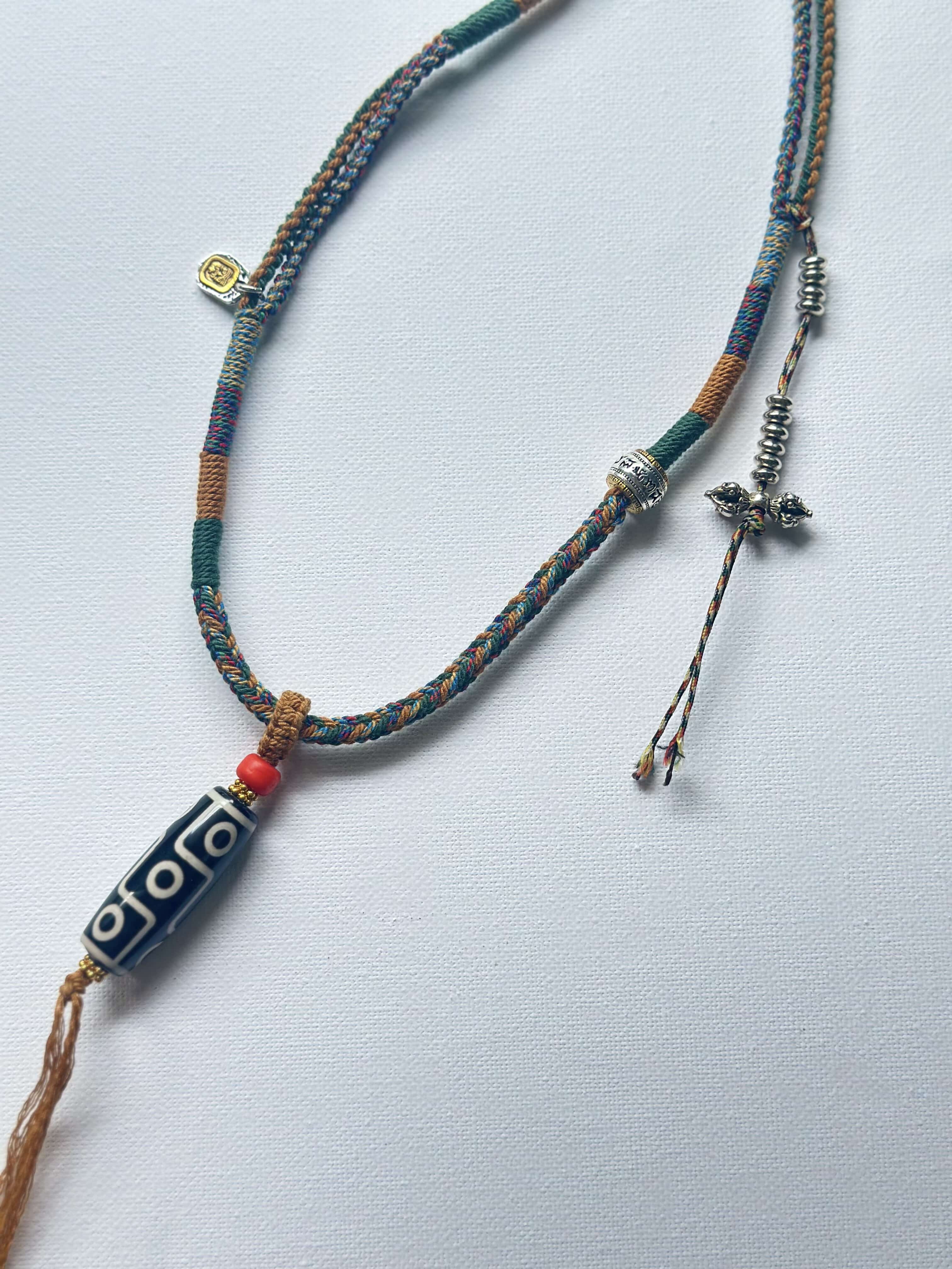 Heavily Handwoven necklace with vintage metal Himalayan accessories and nine-eyed DZI bead