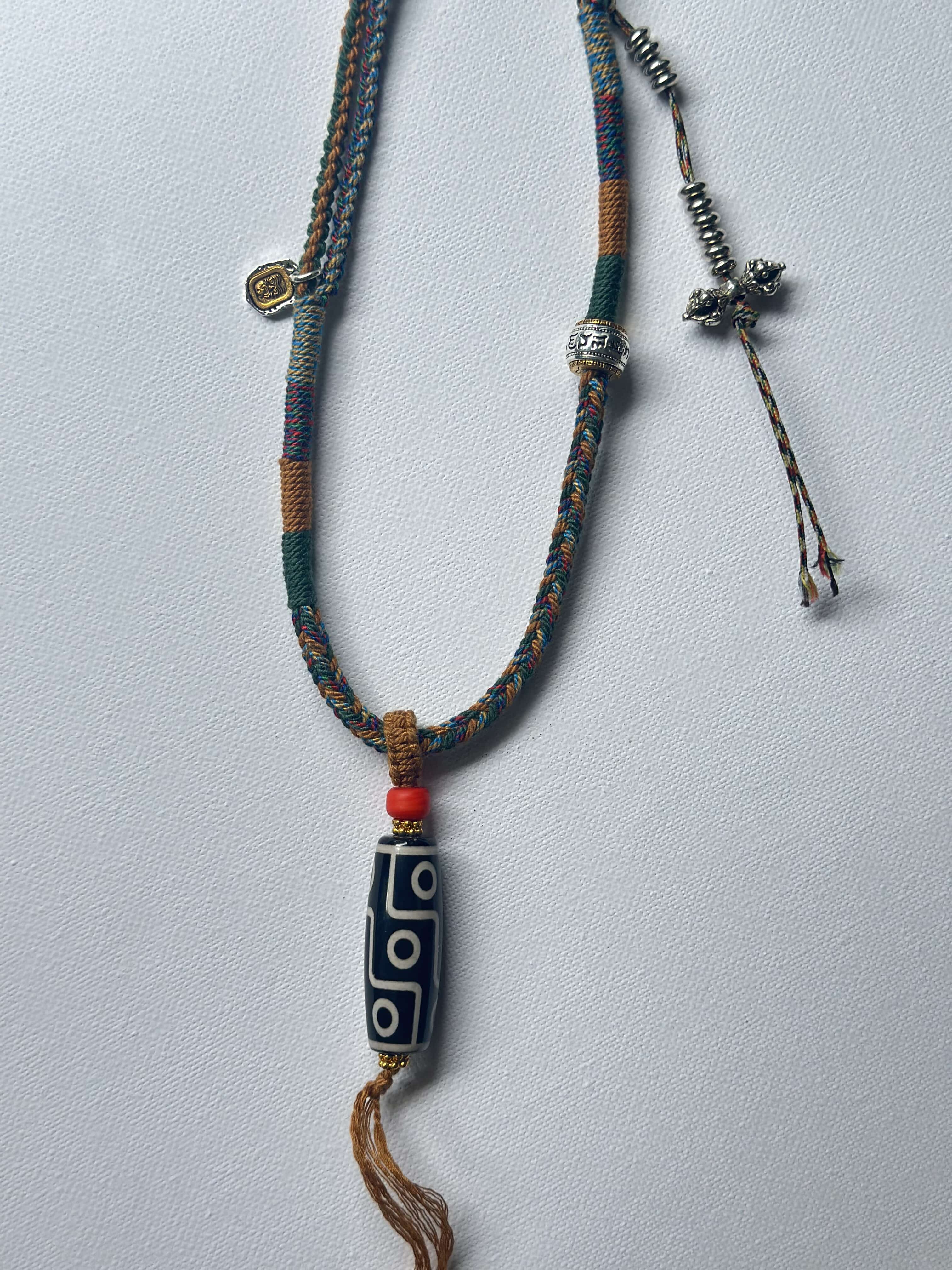 Heavily Handwoven necklace with vintage metal Himalayan accessories and nine-eyed DZI bead