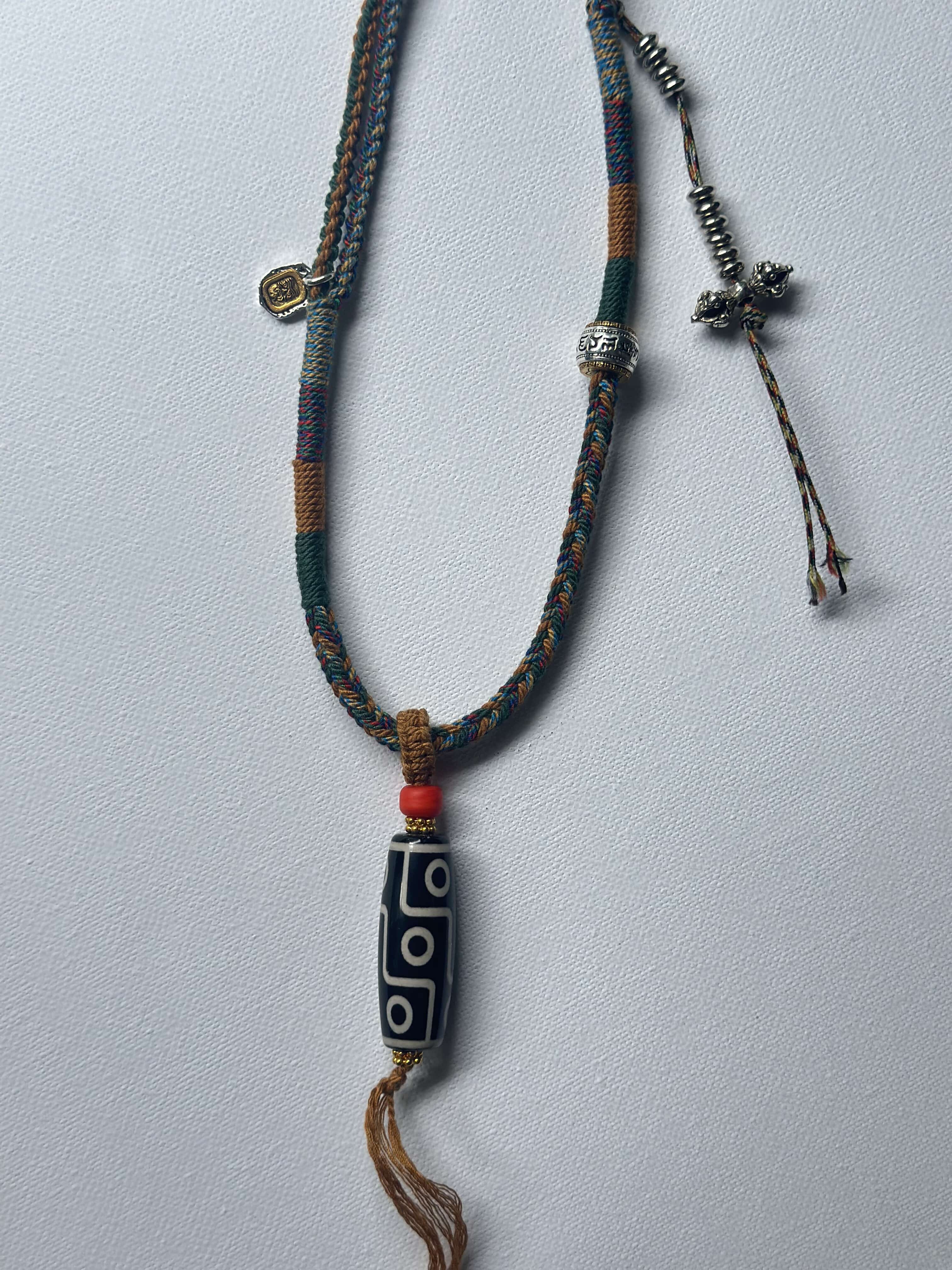 Heavily Handwoven necklace with vintage metal Himalayan accessories and nine-eyed DZI bead
