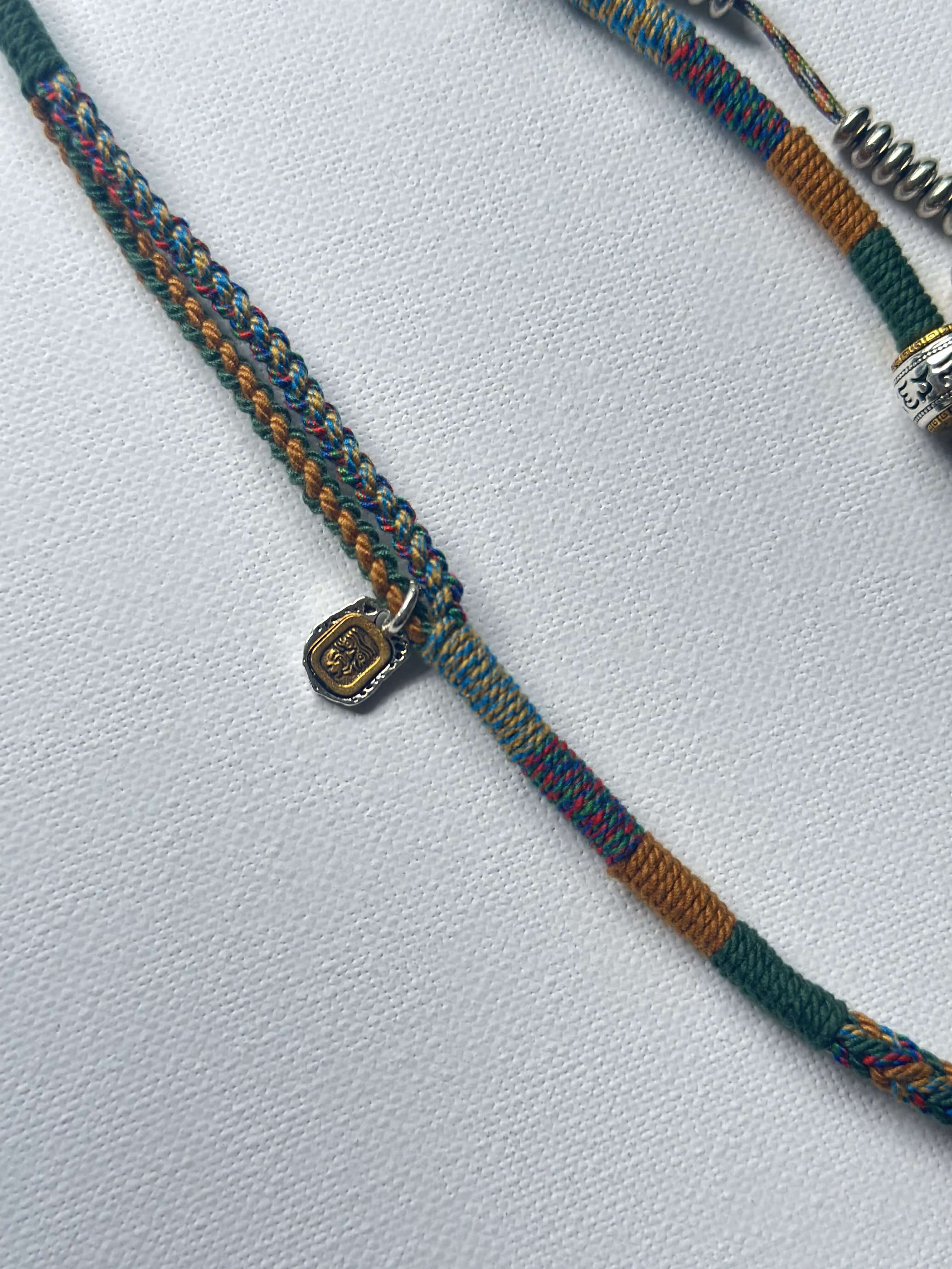 Heavily Handwoven necklace with vintage metal Himalayan accessories and nine-eyed DZI bead