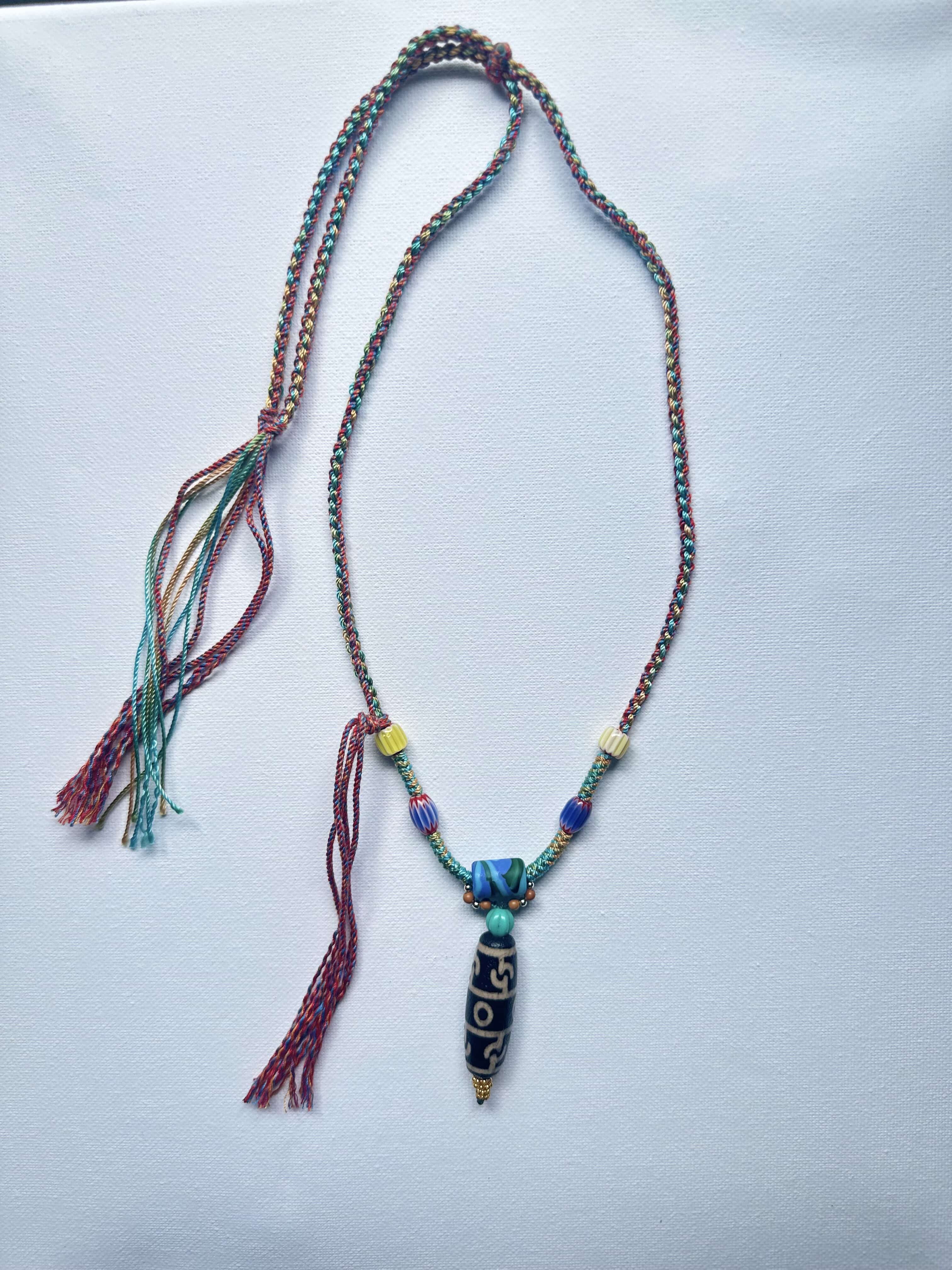 Heavily handwoven with traditional color glass beads and Three-Eyed Dzi of Guru Rinpoche pendant.