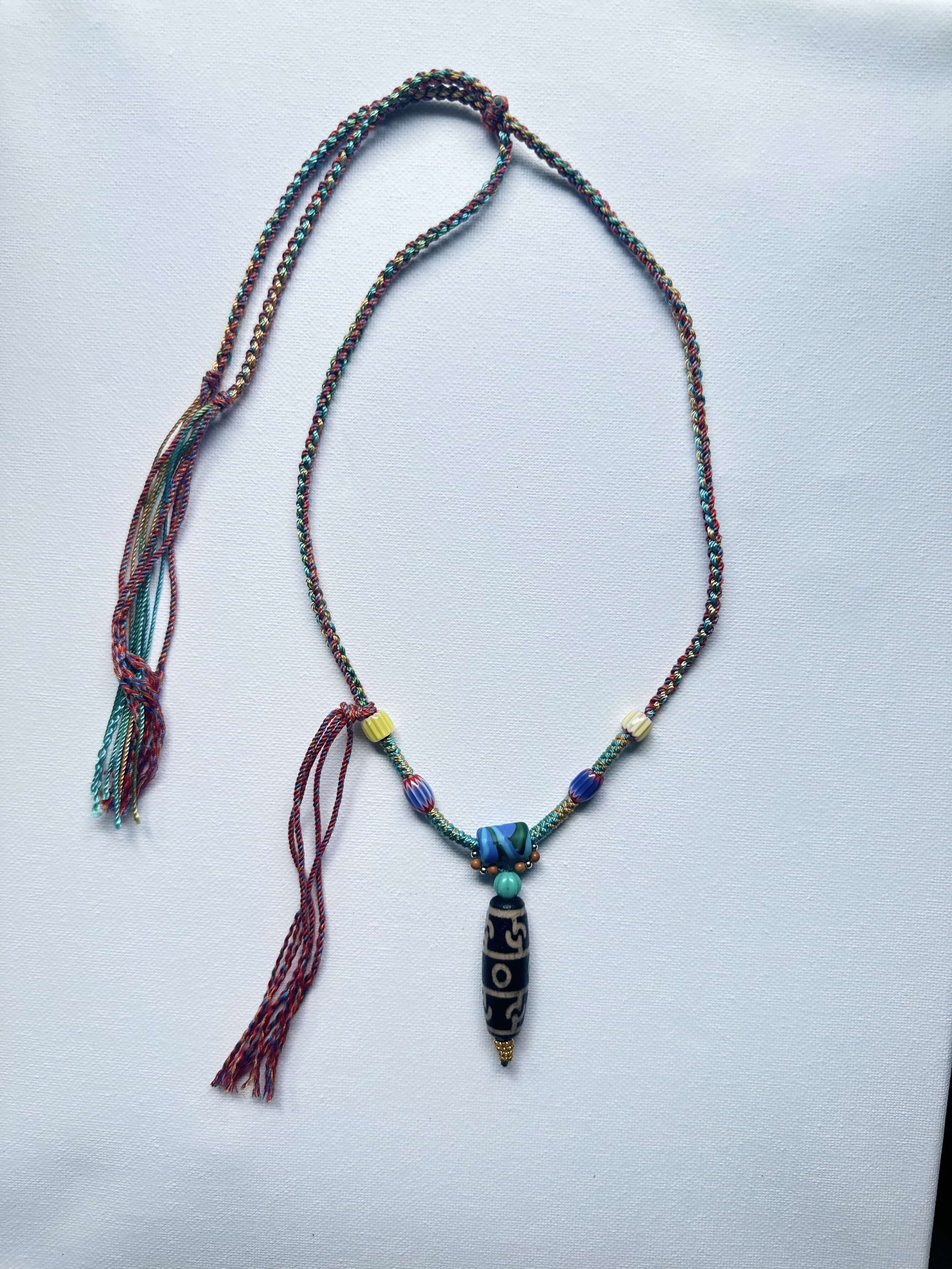 Heavily handwoven with traditional color glass beads and Three-Eyed Dzi of Guru Rinpoche pendant.