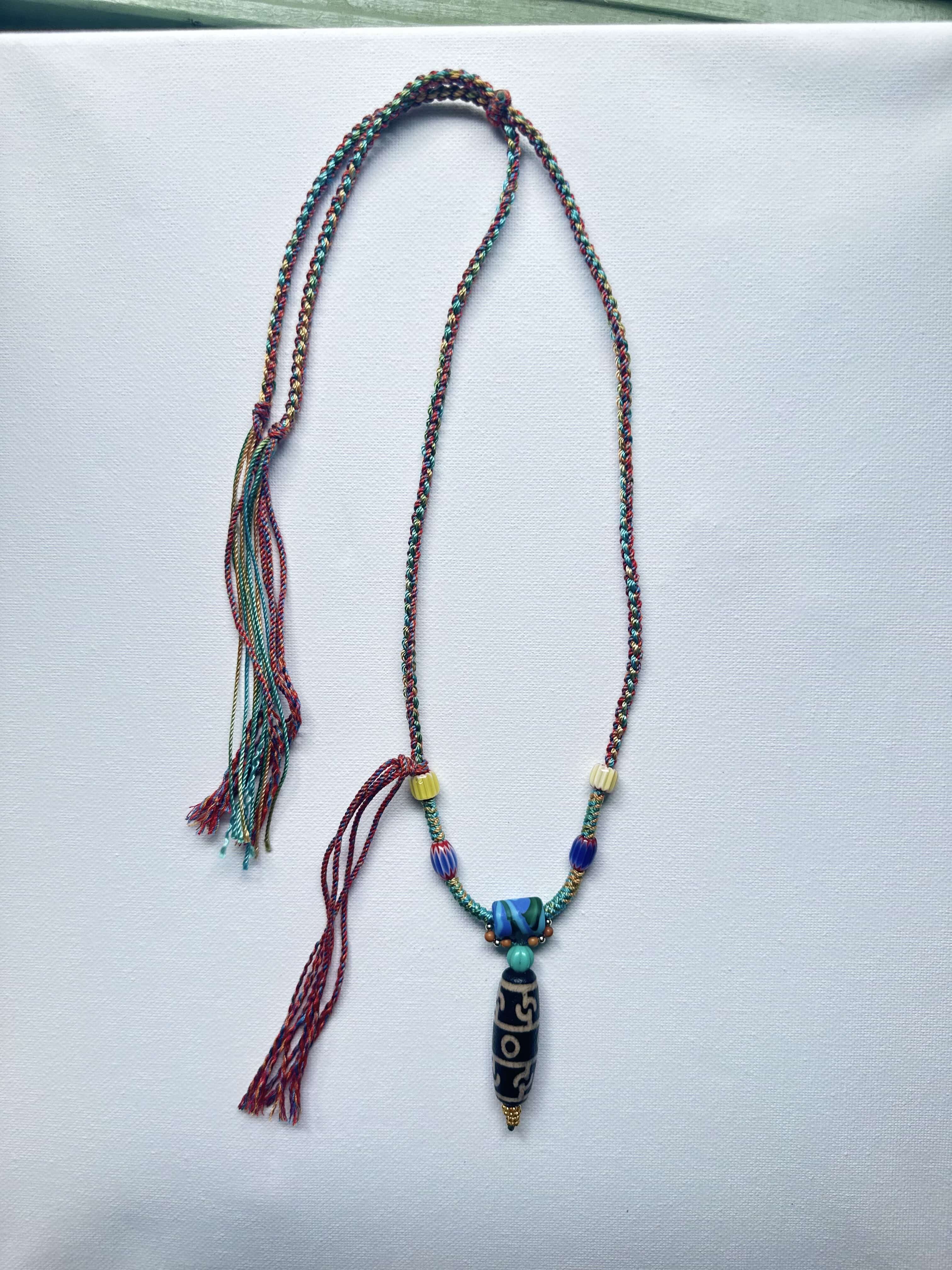 Heavily handwoven with traditional color glass beads and Three-Eyed Dzi of Guru Rinpoche pendant.
