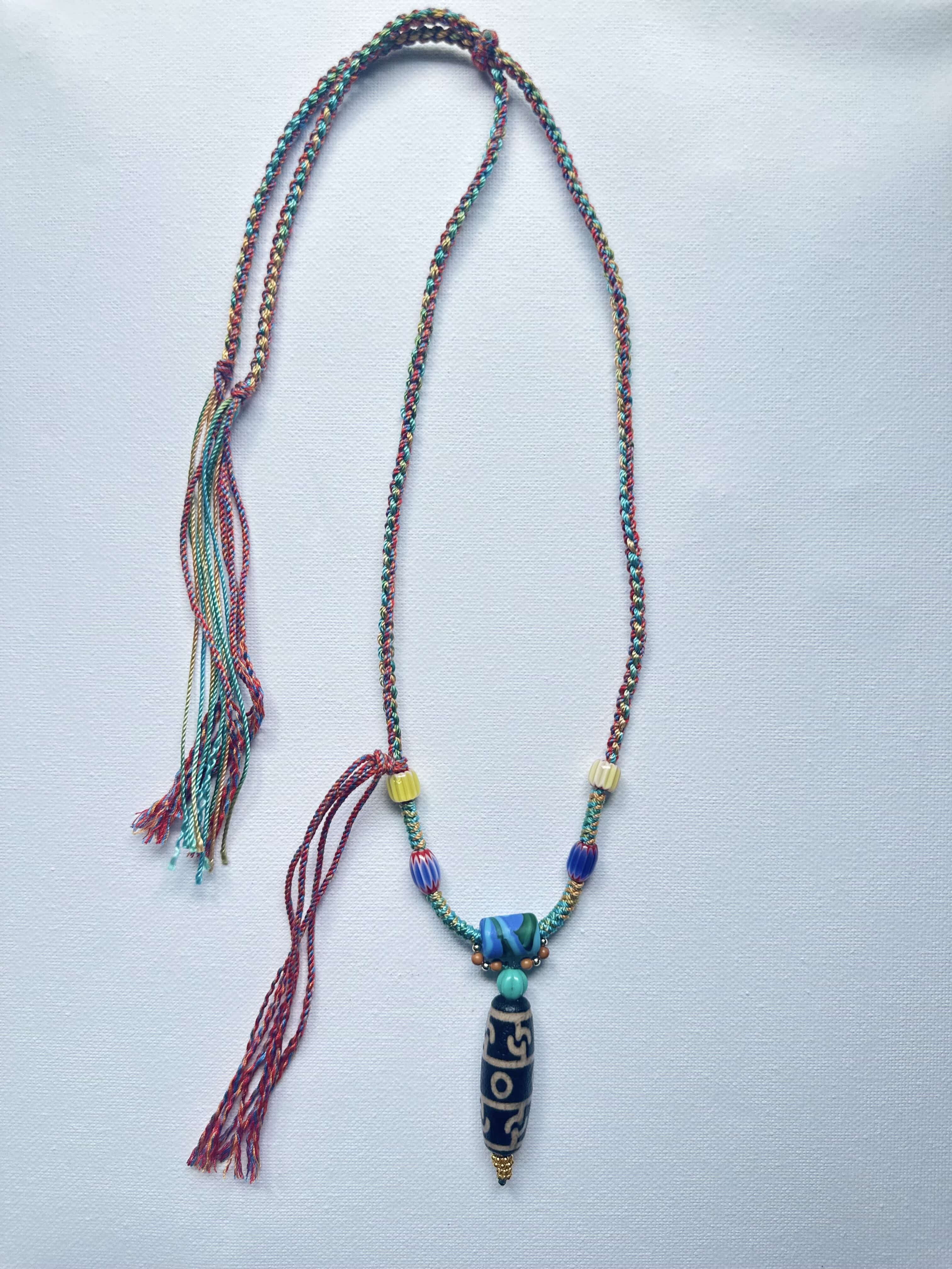 Heavily handwoven with traditional color glass beads and Three-Eyed Dzi of Guru Rinpoche pendant.