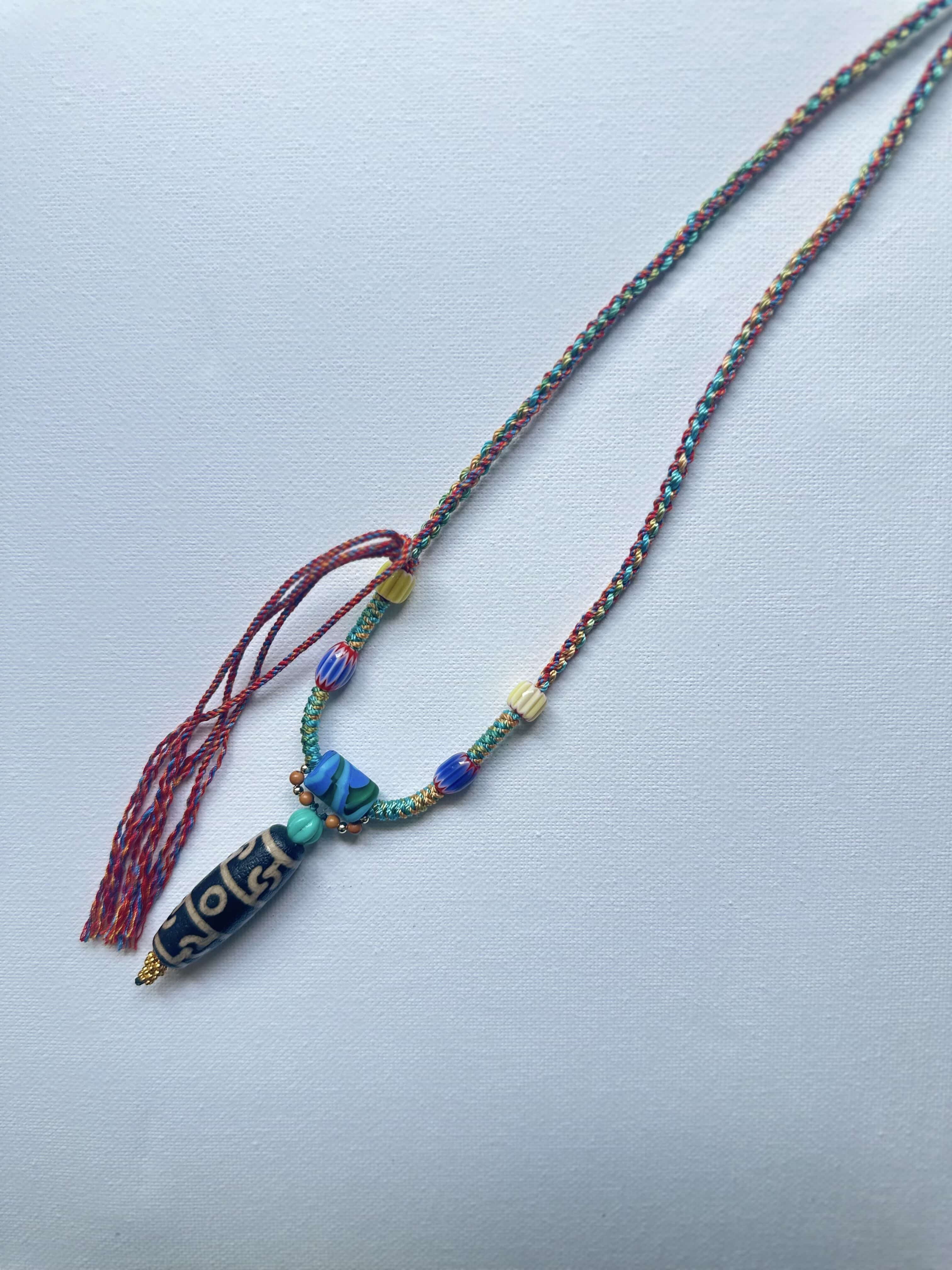 Heavily handwoven with traditional color glass beads and Three-Eyed Dzi of Guru Rinpoche pendant.