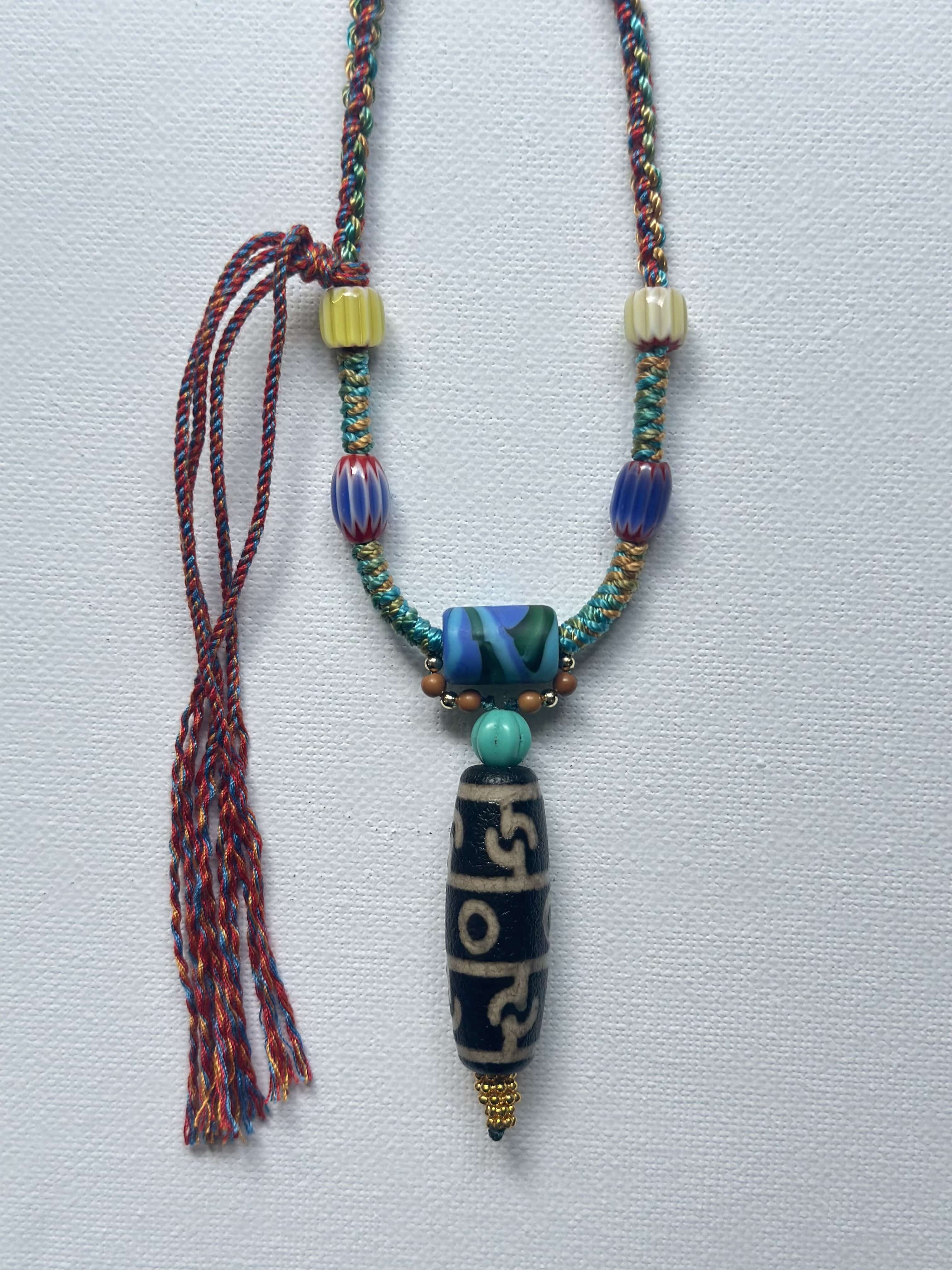 Heavily handwoven with traditional color glass beads and Three-Eyed Dzi of Guru Rinpoche pendant.