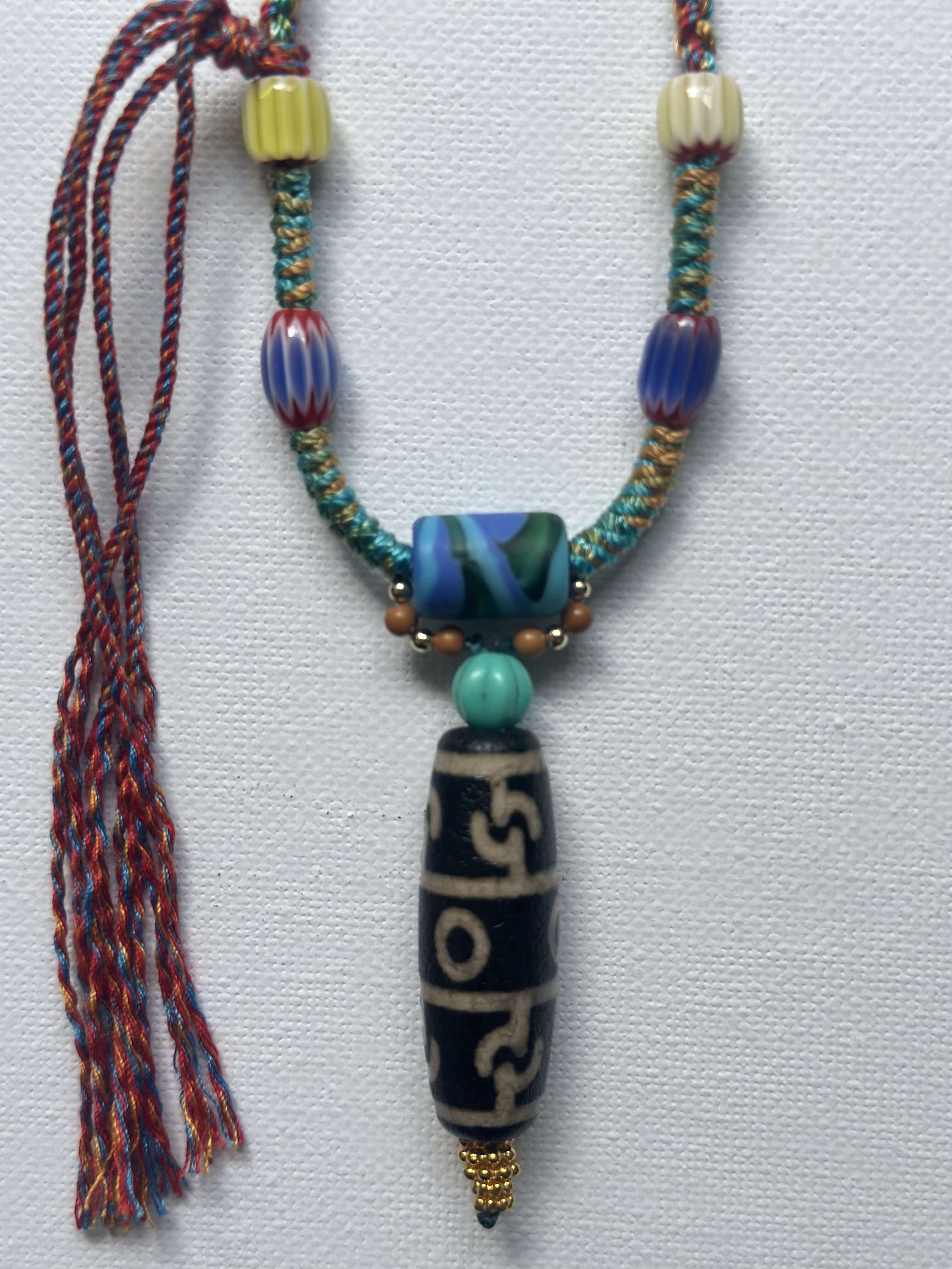 Heavily handwoven with traditional color glass beads and Three-Eyed Dzi of Guru Rinpoche pendant.