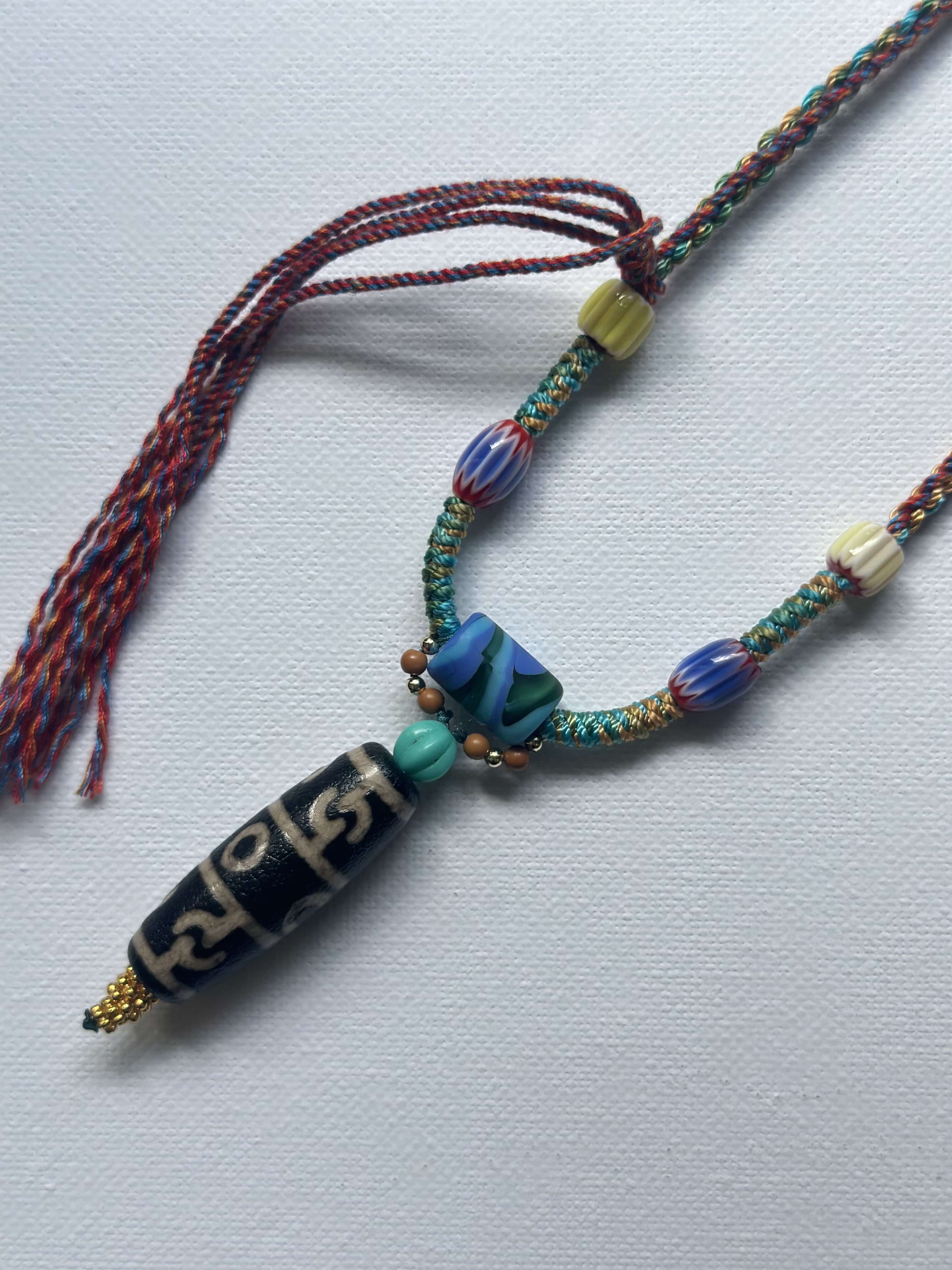 Heavily handwoven with traditional color glass beads and Three-Eyed Dzi of Guru Rinpoche pendant.