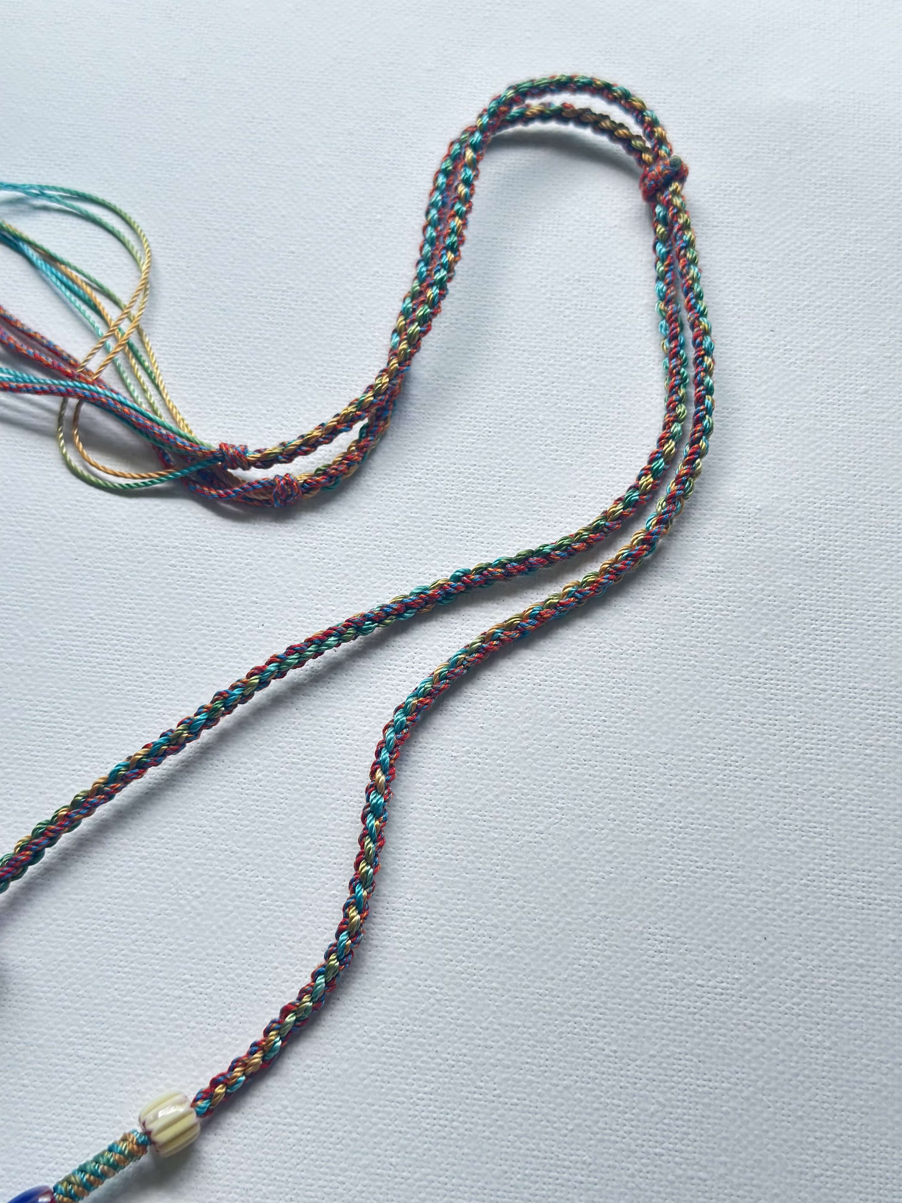 Heavily handwoven with traditional color glass beads and Three-Eyed Dzi of Guru Rinpoche pendant.