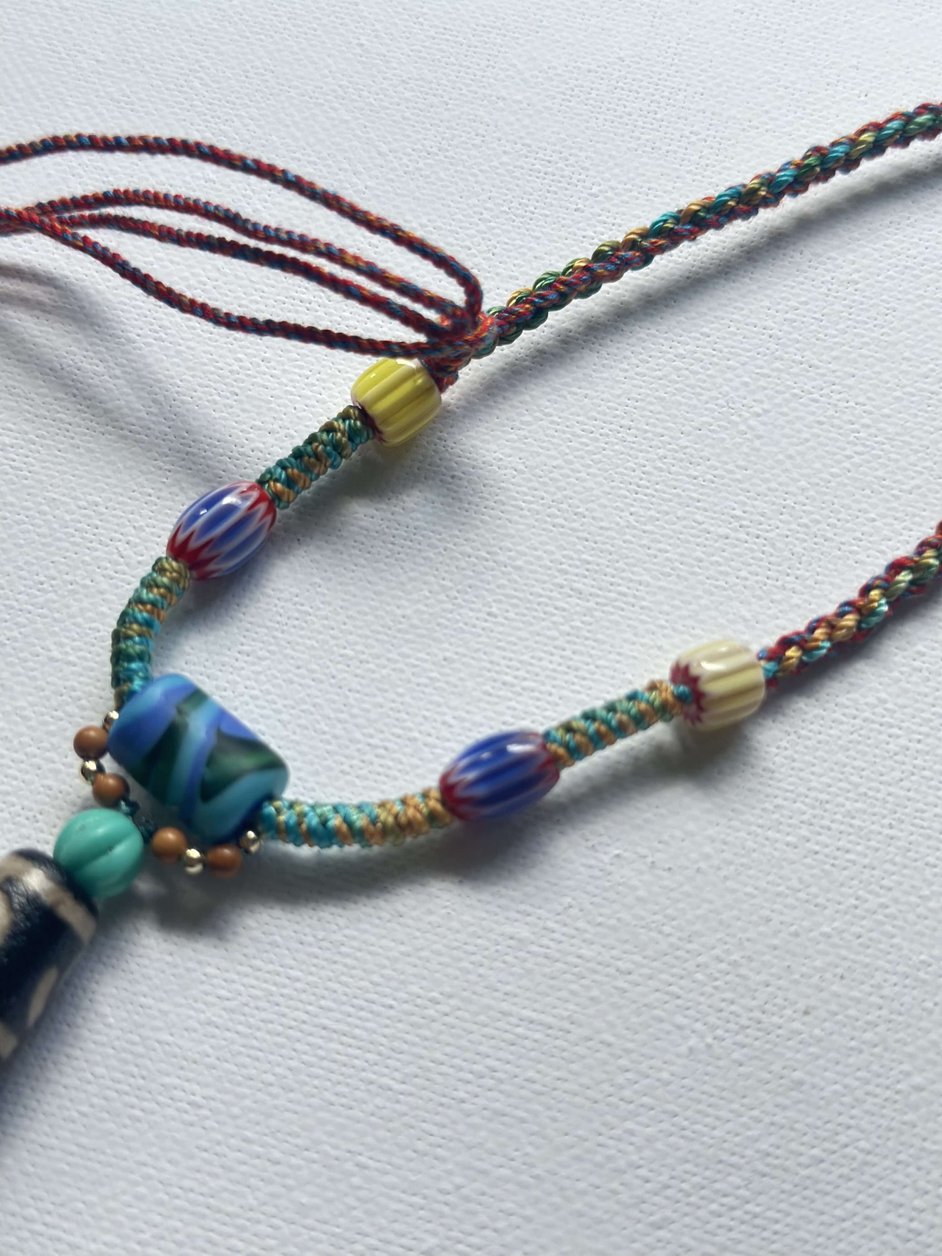 Heavily handwoven with traditional color glass beads and Three-Eyed Dzi of Guru Rinpoche pendant.