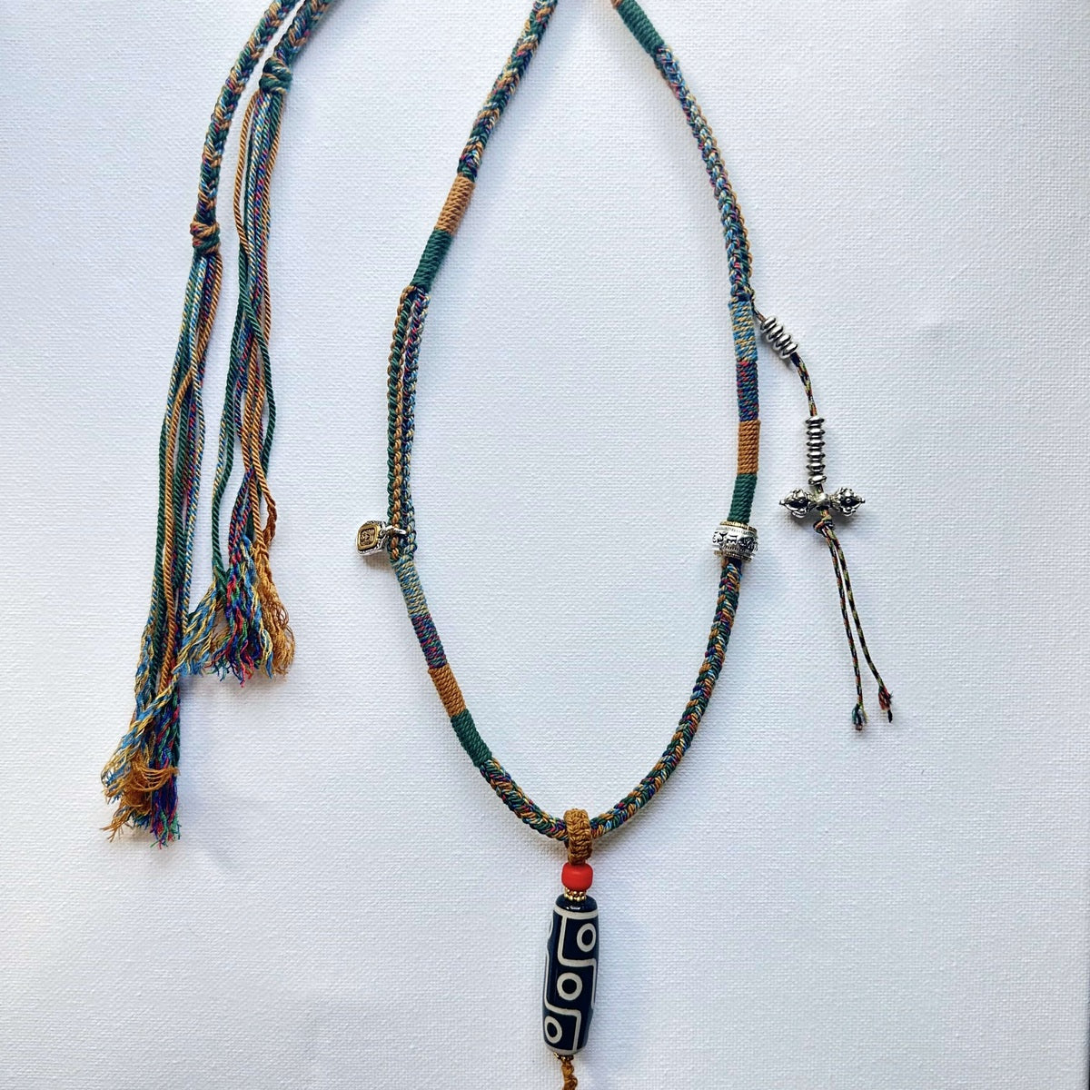 Heavily Handwoven necklace with vintage metal Himalayan accessories and nine-eyed DZI bead