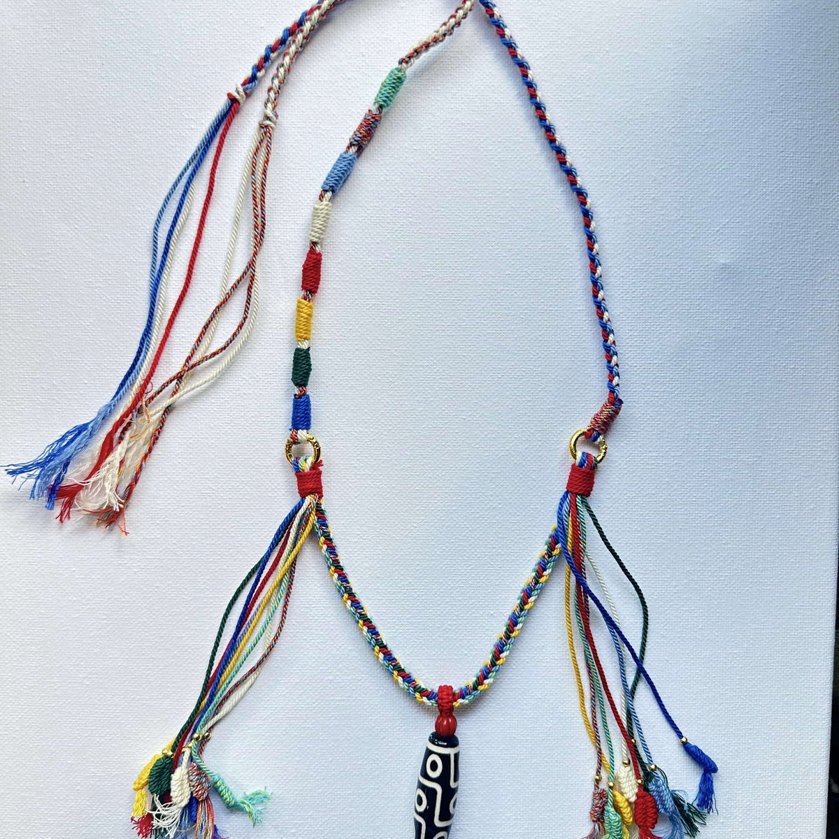 Heavily Handwoven necklace with nine-eyed DZI pendant